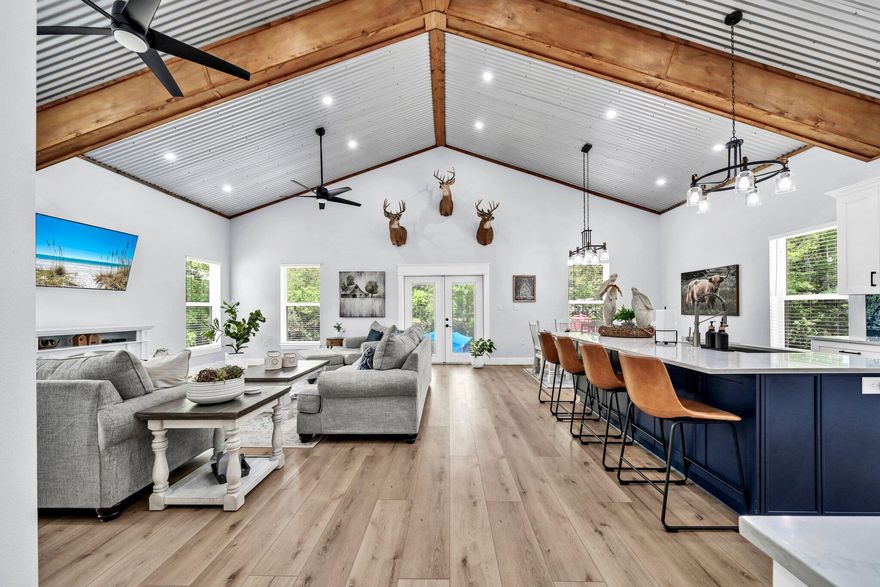 Nestled in nature and a true hidden gem in Walton County, this beautifully designed canal-front home in the peaceful waterfront community of Bunker Creek, offers the ultimate riverfront lifestyle. Perfect for outdoor lovers and fishing enthusiasts, it's just minutes by boat to Choctawhatchee Bay, the Gulf, and Florida's pristine springs. With easy deep-water access and close proximity to Crab Island and Destin, enjoy endless adventure, relaxation, and wildlife--all from your own backyard.This inviting 3-bedroom, 2-bathroom retreat offers a perfect blend of modern comfort and rustic charm and is situated on a spacious lot in a private setting with serene water views along the 67'' of canal waterfrontage with your very own concrete boat ramp. Step inside this Sportsman's dream home to discover a light and airy interior with soaring ceilings, wood-style LVP flooring throughout, and carefully curated finishes. The open-concept living and dining area features a cozy aesthetic and flows effortlessly into the stunning kitchen - complete with a large island, sleek quartz countertops, stainless steel appliances, and custom cabinetry. The corrugated metal ceiling with exposed wood beams adds a unique architectural flair that makes this home truly one-of-a-kind. No detail has been overlooked. From the floor joists to the exterior studs, this home has been built with fortitude and is extremely, energy efficient. Efficiency upgrades include above-par sub flooring, double pane windows, spray foam insulation and double insulation between the laundry and adjacent rooms providing additional sound proofing. The primary suite is a peaceful sanctuary with a beautifully upholstered king size bed, massive walk-in closet, and a spa-like en suite bathroom boasting a glass-enclosed tile shower and double vanity with granite countertops. Two additional guest bedrooms offer ample space with queen beds and stylish touches for family or visitors and also feature large closets. The amount of storage in this residence is impressive with added stowing space in the attic. The walk-in pantry will blow you away with generous custom shelving and even room for deep chest freezer!

Outside, enjoy morning coffee or evening sunsets on the front porch, or take a short walk down to your canal access, perfect for launching kayaks, paddleboards, or casting a line. Bonus: the neighboring fish camp and barn across the road is also available for purchase and would be excellent dry storage for any boats, RVs, ATVs or other off-road vehicles as well as guest accommodations with a full kitchen and bathroom. (MLS # 979796)  
Whether you're seeking a permanent residence or a weekend escape, this property offers the best of relaxed Florida living with modern flair. Located just a short drive from local conveniences, natural springs, and Panama City Beach, this home is a rare find with the highest quality custom upgrades and is not your average "Fish Camp". Relaxation, adventure, and abundant wildlife reside here- and yes, you can have it all! Reach Choctawhatchee Bay in under 10 minutes by boat, cruise up the Intracoastal and pop over to Shell Island or enjoy a short ride under the Highway 331 bridge to Crab Island and Destin. Come live the lifestyle!
