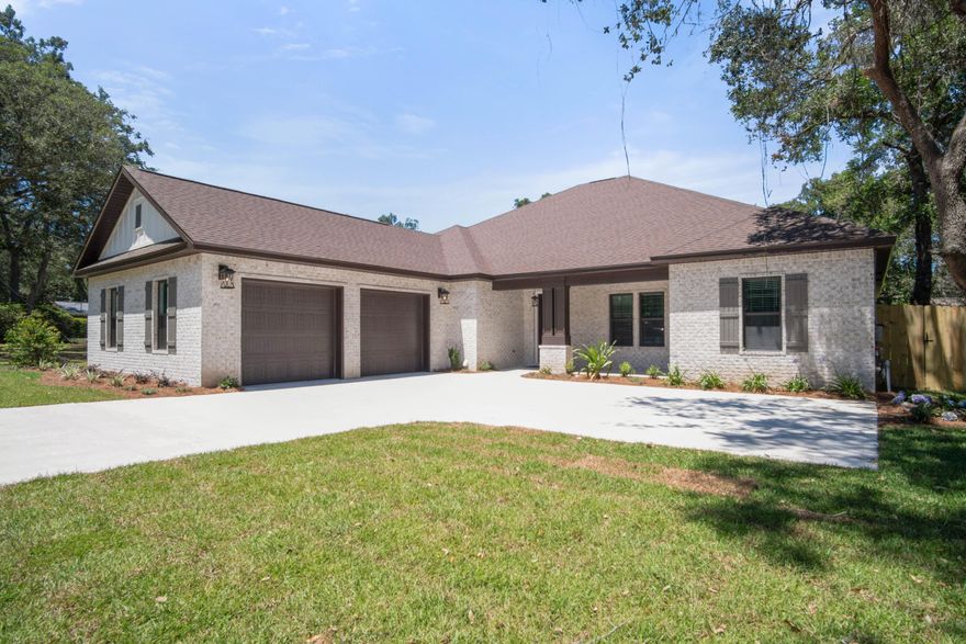 Welcome home to this amazing custom 4/4, 3260 SF., brick home with office on highly sought out Meigs Dr. in Shalimar. This home has super curb appeal and is constructed on a large lot (1/3 Acre), which is a rarity. There are 9 Ft. ceilings w/ impressive crown molding, a trayed ceiling in main living area, interior accent brick wall, solid wood interior doors, 1 x 6 white pine baseboard and 1 x 4 white pine door casing throughout, has LVP flooring in all areas except for bathrooms, where there is porcelain tile flooring. All windows and exterior doors are impact glass which will be an insurance savings. At the front of the living room is the gourmet kitchen which boasts solid wood white cabinets, 42'' wall cabinets with crown molding and a light bar, a mosaic tile backsplash,