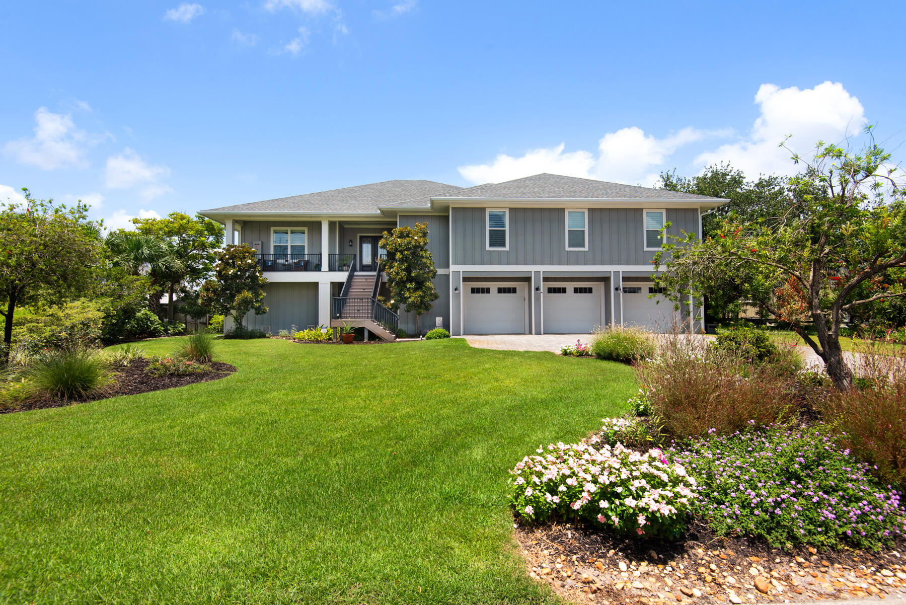 This charming coastal canal-front home in Villa Venyce in Gulf Breeze built by Sprague Construction offers a perfect blend of comfort and elegance. Nestled in a picturesque canal neighborhood, this residence boasts stunning views of canal sunsets and wildlife entering and exiting the canals. Hop in your boat for a 10-minute boat ride to the soundside of Flounders, Paradise, and Whiskey Joe's. The property features a spacious living area, with a bright and airy living room, a modern kitchen equipped with stainless steel appliances and granite countertops, and includes a dining area ideal for family gatherings. The home includes five bedrooms, each designed for relaxation, with ample closet space and large windows that flood the rooms with natural light. The master suite is a lovely