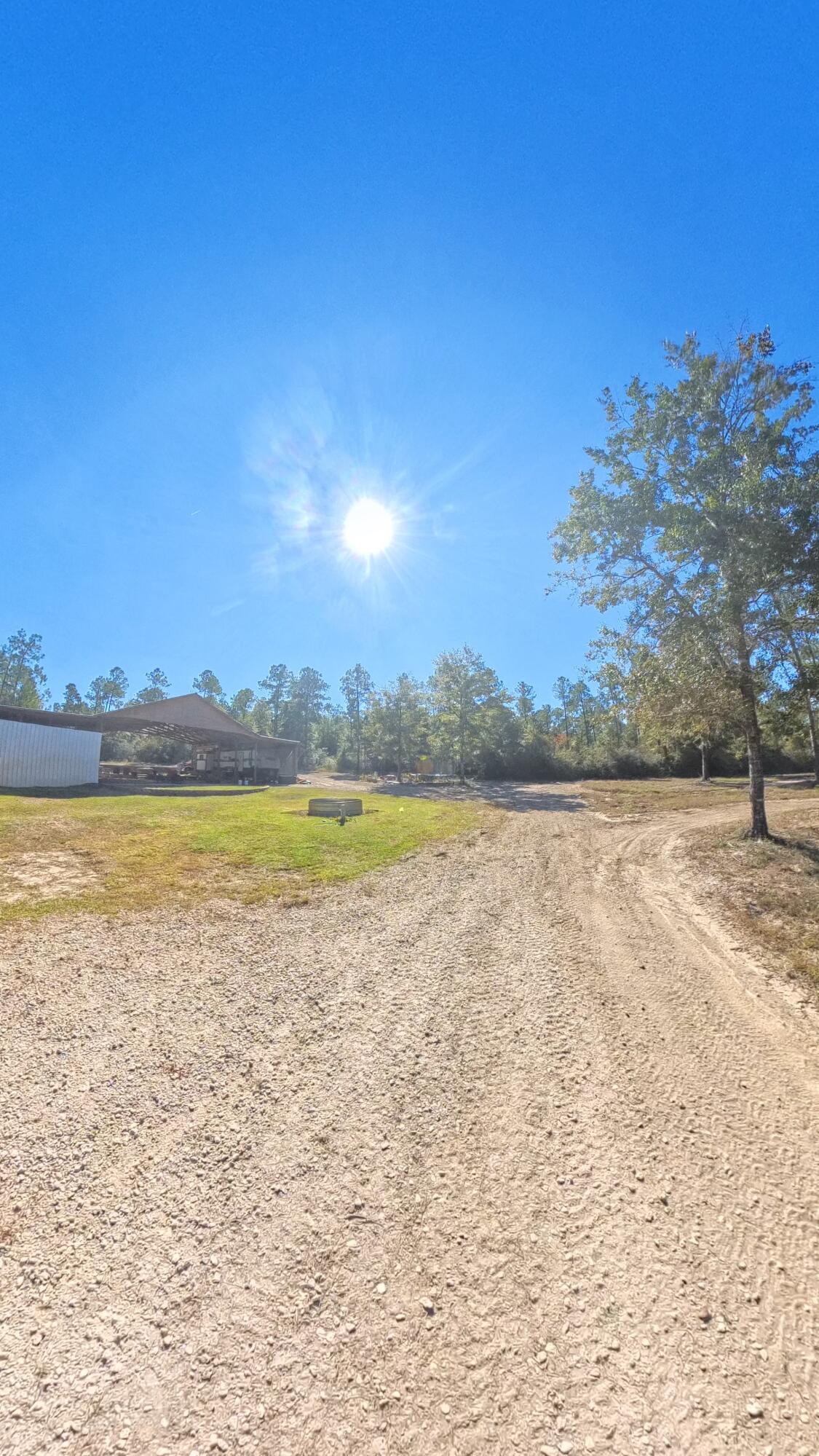 10.5-acre fully equipped outdoor retreat perfect for recreation, hunting, or full-time living. Features a 40x80 covered pole barn with outdoor kitchen and composite deck, plus two outdoor showers and a laundry room with toilet. A kids' ATV track offers family fun, while the back acres are set up for hunting. Includes a finished 12x24 cabin and a 12x40 insulated, unfinished cabin ready for your finishing touches. Two 50-amp camper hookups with water and sewer are ideal for RVs or guests. Additional structures include a 20x20 metal-framed carport, a small shed, and a cattle trough. A rare turnkey setup with room to play, relax, or expand--schedule your showing today!Buyer to verify any and all information deemed important to them.
