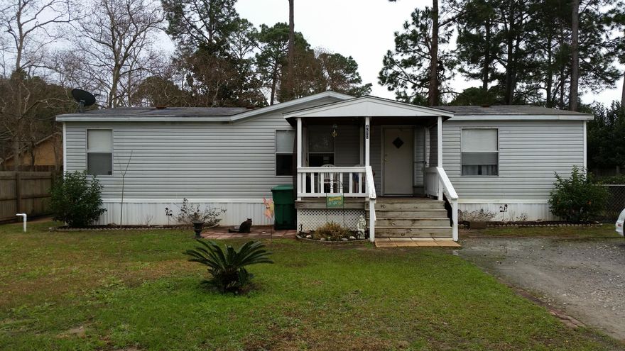 Nice lot and mobile home in residential neighborhood convenient to Hurlburt Field AFB and it qualifies for Rural Housing loan. This 1998 home offers vaulted ceilings throughout. The large kitchen features an island and plentiful cabinets and work space. Living room is open to dining area which opens to kitchen for a spacious feel. Inside laundry room is just off the kitchen. Split master bedroom plan has walk-in closet plus wall closet. Master bath has separate shower and garden tub. Covered front porch welcomes you home. Ready for immediate occupancy, this could be your new home.