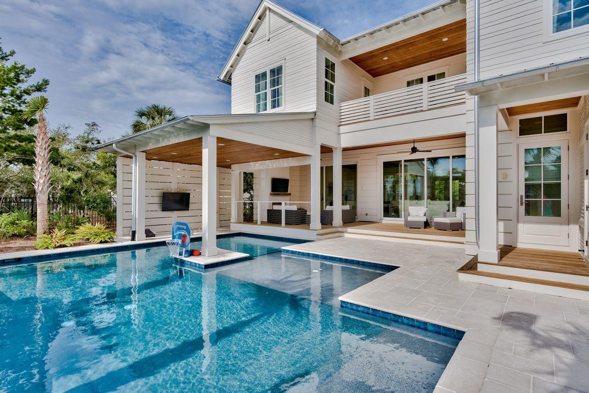 Ideally located in Blue Mountain Beach, this recently constructed home is perfect as a vacation rental or as a primary residence. Outdoor living is exemplified with an oversized private pool featuring a swim up bar, sun shelf, and cabana, as well as an expansive covered patio with outdoor fireplace, TV, grill, ice maker, fridge and multiple seating areas. Inside, the main floor is highlighted by the gourmet kitchen and spacious living room, which features 12 foot ceilings ,shiplap, and rustic beams. The spacious bedrooms each feature their own en suite bathrooms, as well as sizable closet space.