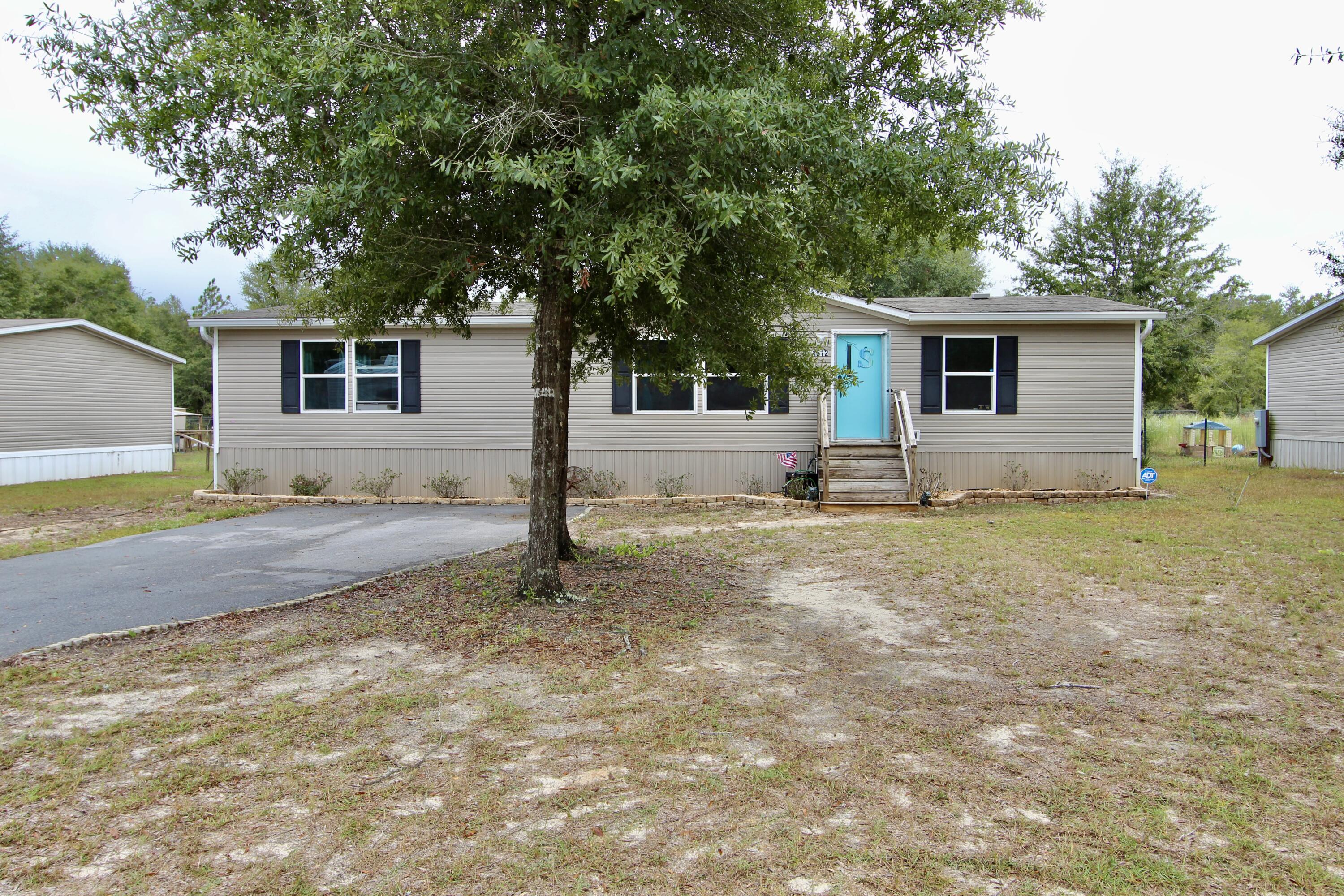 This manufactured home sits on a 1/2 acre lot.The home features an open and spacious floor plan, kitchen has an island, a separate utility room. Split floor plan for privacy. The home is prewired for home networking and prewired for Starlink satellite internet. The master suite is spacious and the master bath has a tile shower and walk in closet. There is a large open deck off the dining area. The back yard is large and has plenty of room to roam. There is a large shed to store all your lawn equipment. It has a RV hock up and the drive way is paved. Schedule your tour today!