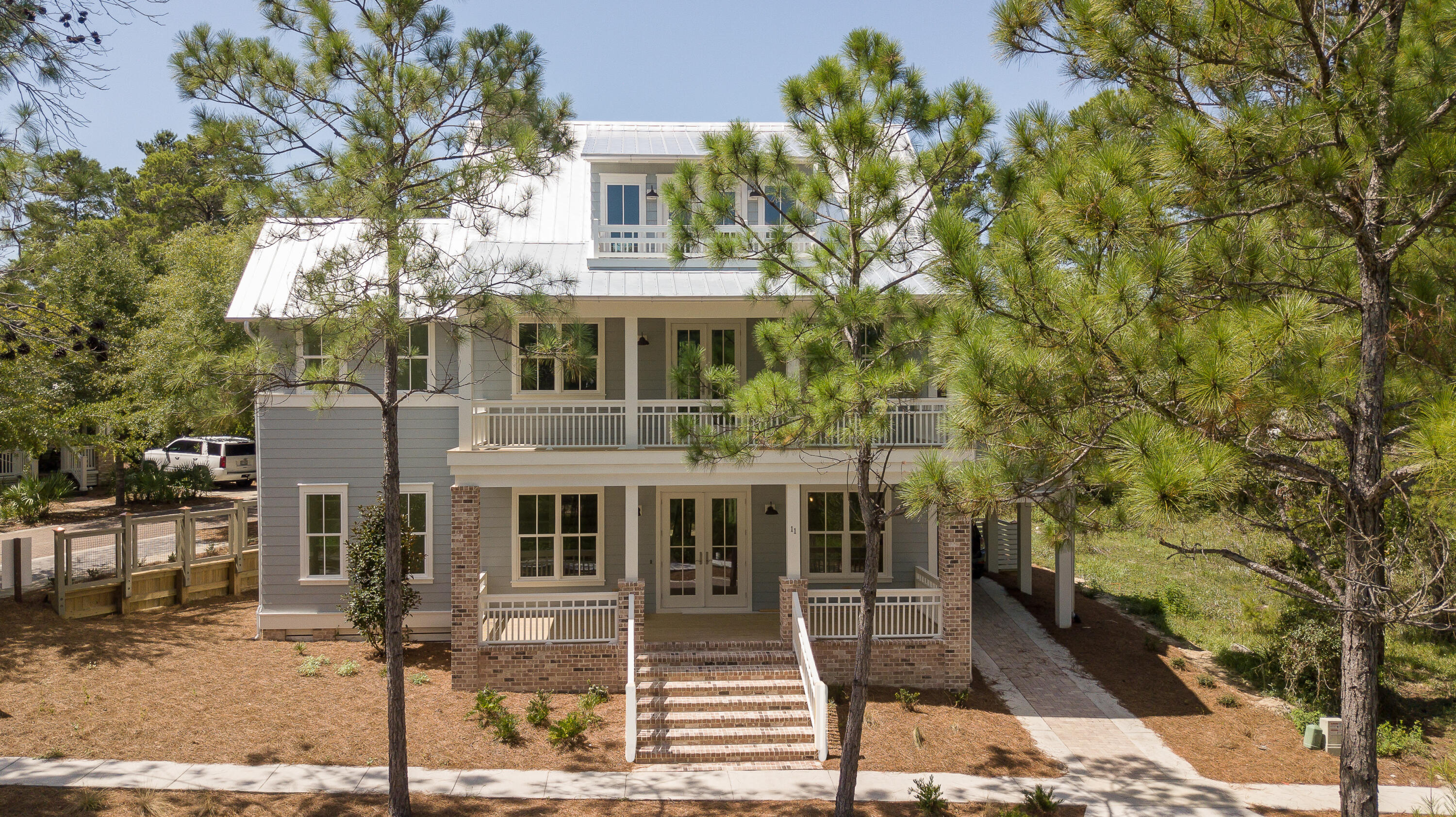 Here it is!!!!! A custom built beautifully furnished home in  30A's most sought after neighborhood, Forest Lakes.,30A's best kept secret. This is a majestic 3 story coastal beach house resting on a corner lot gazing at the beautiful lake views from all 3 levels. Front stairs lead you up to the entrance of this grand home opening into a spacious living and dining area, wrapped in whitewash shiplap and cozy fireplace. This is the open living concept at its best. Gourmet kitchen, great for entertaining.   kitchen island, wolf, subzero appliances for preparing that gourmet dinner . Wine cooler, farm sink, potfiller, cabinets to the ceiling and many more upgrades. Spacious five bedrooms with 5 bedrooms and 5 and one half baths. Third floor can be  5th bedroom or game room, etc. Attic is climate