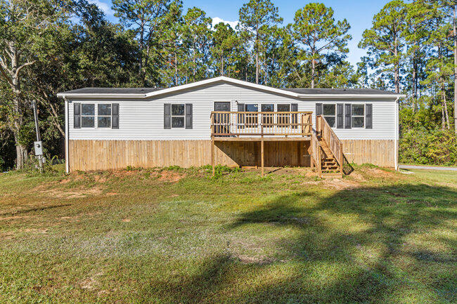 **Price Improvement**This home is situated on a .45 acre corner lot, with a open and airy floor plan. Features 3 bedrooms, large closet in primary, 2 baths, primary bath has dual vanity, garden tub and walk in shower. New LVP flooring, new carpet in the bedrooms, fresh paint. Formal dinning area, celling fans. Front deck to kick back and relax. Conveniently located with access to the 1-10 and Black Water River. Call today for a private showing or call your favorite Realtor to view! Professional photos coming soon!