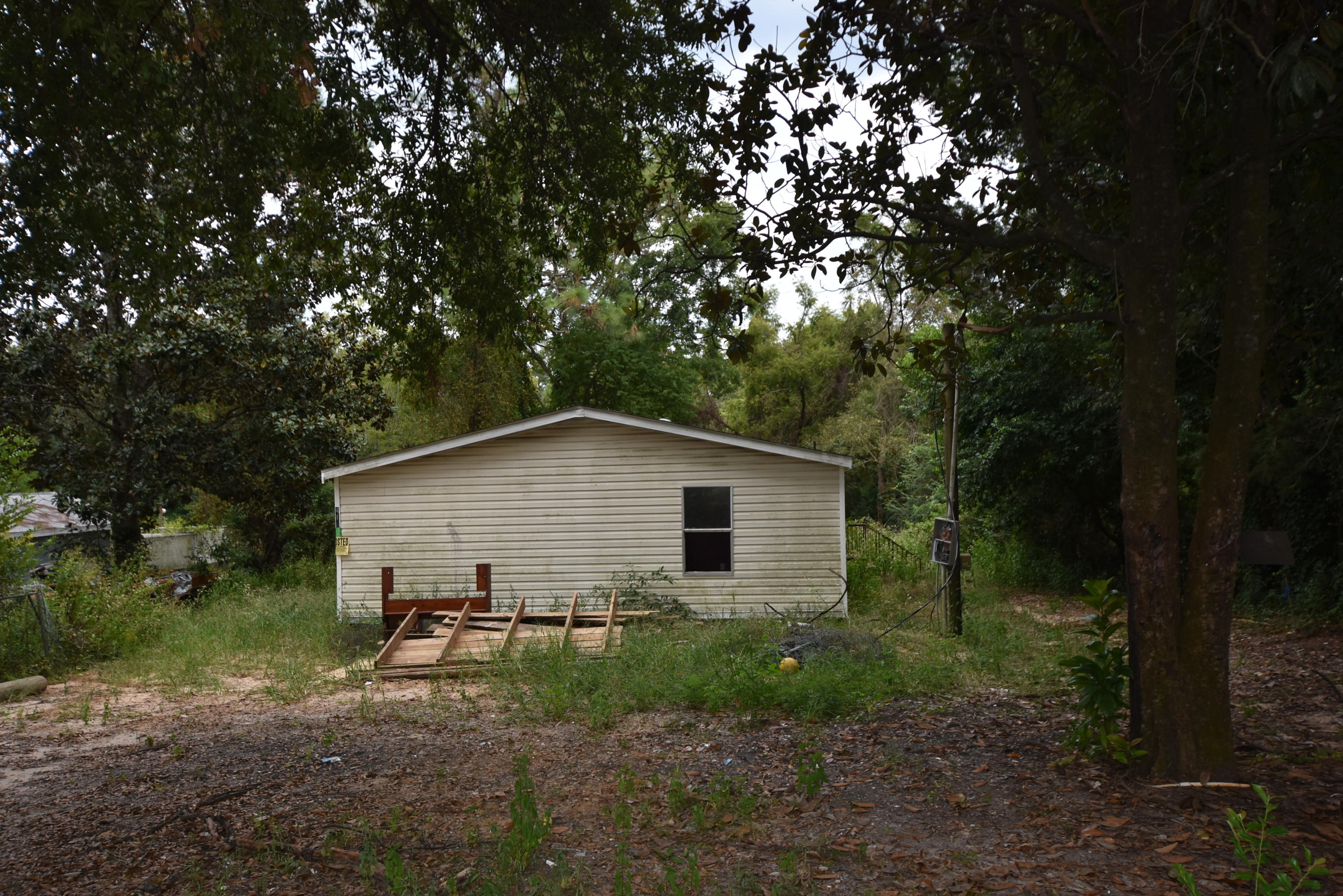 The mobile home and land was repossessed by the Trust. Mobile home conveys ''AS IS''. Property is located in the county so no city taxes. Zoning is R-1 and Future Land Use is LDR. Aerial shows a stream and possible wetlands just past the midway point of the property. Although it is a narrow lot, there is plenty of room for a garden! Mobile Home need work so this might just be the project you are have been looking to find!