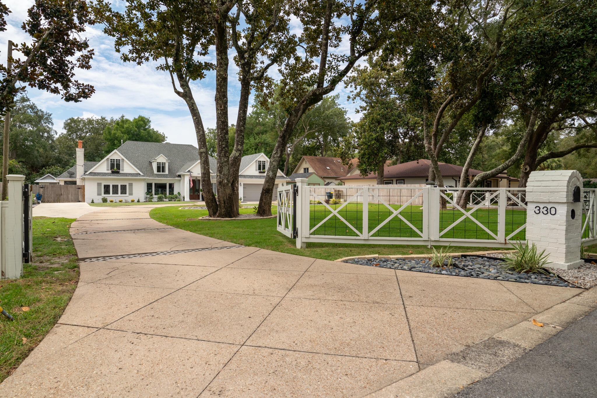 Location, charm, character, quality and features galore in this golf cart friendly neighborhood! You'll appreciate the newer roof (2019), 2 Daikin HVAC systems (2020) with smart thermostat and all new ductwork, Rinai tankless gas hot water heater, new high impact glass living room window (2023) and more! Relax and enjoy the laid back Florida lifestyle as you float in your private pool or bring your boat 1 block to the boat launch and intercoastal waterway. Step through the custom double front doors into this timeless classic and notice the refinished solid walnut wood flooring downstairs, new carpet upstairs and fresh paint. There are so many unique features in this home that include beautiful wainscoting, original paneling, custom millwork, custom interior doors, READ MORE>>> custom interior wood doors, penny tile and a classic wood burning fireplace. Custom built-ins that include a concrete shelf and repurposed original windows tell a sweet history of the home. Plenty of storage space, recessed lighting throughout and a first floor indoor/outdoor speaker system are a bonus too! Your new home will be a breeze for entertaining everyone. Welcome friends and family with a space and place from the formal living room to the family room, formal dining room, eat-in kitchen, an office/flex space. Gather in the kitchen around the macabus quartzite counters, notice the wood shaker cabinets w glass inserts, kitchen pantry, deep stainless steel sink, gas 5 burner stove with pot filler, new dishwasher and French door fridge. You'll find 4 bedrooms/4 bathrooms (3 beds w/ private baths). There are 2 master bedrooms (1 upstairs and 1 downstairs) which makes this an option for multi-generational families. The upstairs master suite is a retreat you'll enjoy with high ceilings, separate garden tub and walk-in shower for two, 2 new vanities and 2 walk-in closets. Outside, entertaining includes so many options including a covered patio with kitchenette and counters for extra eating/seating space. The screened lanai keeps bugs and leaves out of your glistening gunite pool. The low maintenance, salt system saves money using less chemicals and is gentler on your skin! The pavered patio is just the right spot for your fire pit as your friends play corn hole in the grassy area of the backyard. The little "She Shed" is just right for gardening, extra pool toys, or a playhouse and take a look at that workshop! The 12x24 workshop is ready for all your projects with power a ramp, roll up door and portable heat/AC. This lot is almost half an acre that is fully fenced! Your dogs and kiddos can roam freely with privacy fencing in the backyard and custom, gated fencing in front. You can park everyone's car in the circular drive and also your boat or RV in the extra concrete pad with 50 AMP power hook up and sanitation station! Don't miss the automatic sprinkler system and lawn pump/well. Azaleas, hydrangeas, palms, river rock and more add touches to your landscaping. The 2 car garage includes a sink, pegged wall storage system, stained concrete floor, pull down stairs and a garage attic storage system. Spray foam insulation is energy efficient and the brick & block construction make this a solid well built home. Technology touches include a media closet with whole house ethernet connections, AT&T fiber hook up in place with Cox Wifi Homelife and Direct TV capability. You have to see this home to truly appreciate this Elliott Point gem right down the street from the neighborhood park, boat launch and neighborhood beach! Extensive renovations through the years and recently so the actual year built is 1954 but effective year built is 1984. Don't miss this rate! You might even qualify for the 2.5% interest rate loan assumption!