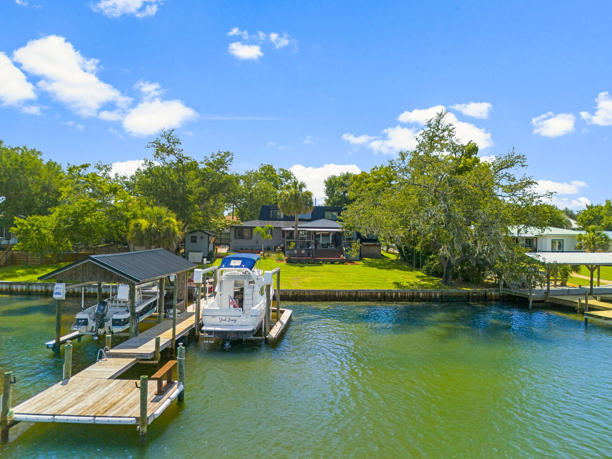 Welcome to your waterfront paradise directly on the water! Perfect for nature enthusiasts, this beautiful east-facing home offers a serene escape where you can fish, boat, or simply unwind on the shaded covered deck overlooking the bayou. Sit on the dock and watch dolphins, manatees, pelicans, osprey, or the mullet jumping. Enjoy stunning moon rises and avoid the hot west sun, making your evenings cool and comfortable. For avid anglers, the dock provides prime fishing opportunities for redfish, trout, blues, mullet, and a variety of bait fish. With direct access to St. Andrews Bay, East Bay, and the Gulf of Mexico, your boating adventures are just moments away. Enhance your waterfront lifestyle with a 2002 Bayliner 2858, boasting only 520 hours. This pristine 30-foot boat features a comma