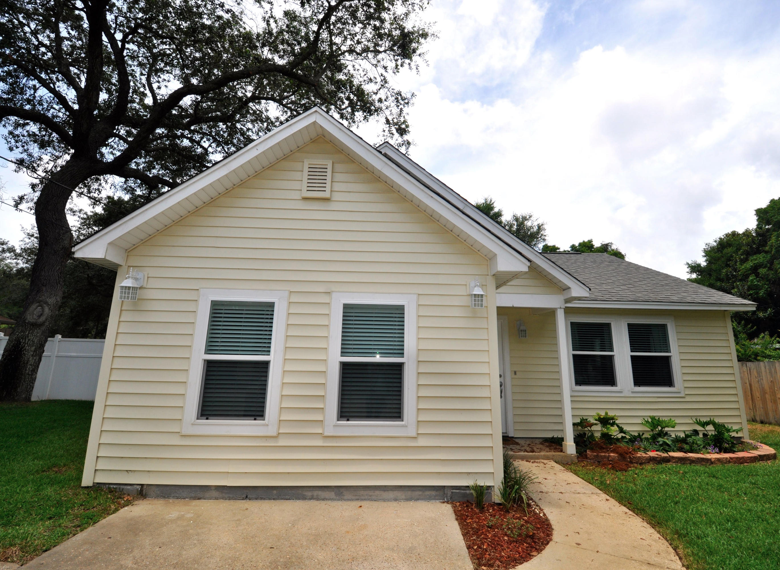 Charming newly remodeled home with new flooring and granite countertops. The master bath has a soaking tub and shower with new tile and a skylight, new vanity in the second bath as well. With a large fenced in yard and a gorgeous in ground pool that is screened in. This is a sweet neighborhood and this home is well kept and beautifully landscaped. Beautiful inside and out. The neighborhood is centrally located and also well maintained. This home has cathedral ceilings and a ''Florida Room'' that is both heated and cooled and opens to the pool. Oversized parking - perfect for a boat! and your are just a stroll to the bay and right around the corner from the boat launch. New hurricane grade windows and huge shed in the back for storage. Ask about our owner credit at closing!