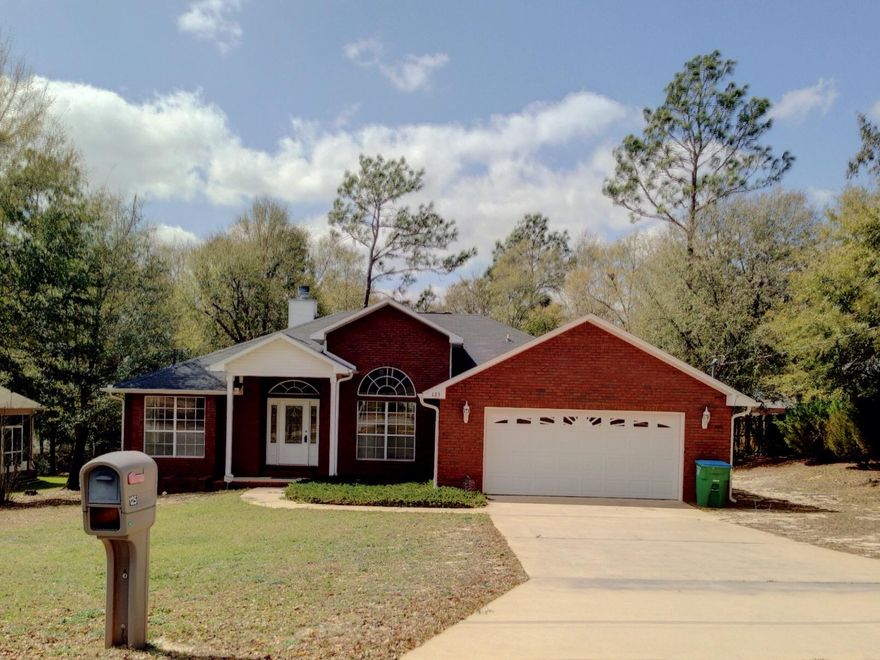 This all brick home is move in ready with new carpet and new paint in a neutral color palate. An upscale contemporary split floor plan with 13 foot ceilings in the dining room, cathedral ceilings in the great room and tray ceiling in the master bedroom. Tile in the kitchen, living room, master bedroom and both baths. Wood floors in the dining area. Carpet in the bedrooms. Entertaining made easy with the beautiful tall oak cabinetry, ample counter space as well as a bar that overlooks the breakfast nook and great room. The spacious and well appointed master bath features a jetted soaking tub, separate shower, double vanities and huge walk in closet. Enjoy the sunny Florida weather under the 9x12 covered back porch or the large extended deck. A 16x22 storage bldg in the fenced back yard.