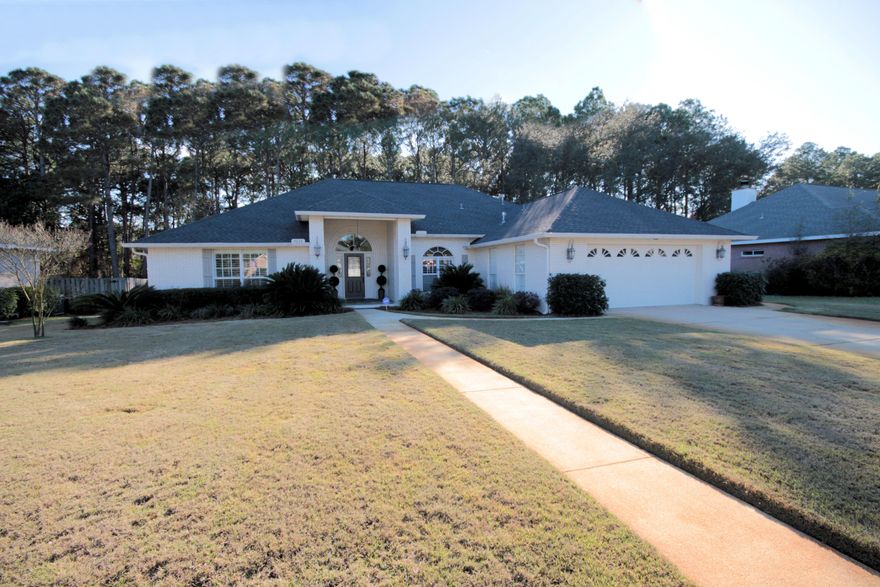 The detail and style that makes this home so special is apparent as soon as you walk up to the grand entrance. The door and front windows are framed in with ornate brickwork and topped with arched windows that allow the natural light to pour in and kiss every inch of this 2550 ft. Haven. Nothing has been overlooked in the design and build of this gorgeous home. Enjoy the fellowship and convenience of an open floor plan, but privacy of split bedrooms. Your foyer welcomes you into a large living space with hand scraped hardwood floors, crown molding, high ceilings, recessed lighting and an elegant gas fireplace. You'll actually enjoy being in this decadent dream kitchen with its stainless-steel appliances, gas stove, granite countertops and breakfast bar. The sun-drenched breakfast nook is sure to start your day off right or dine like royalty in the separate formal dining room. The breakfast nook opens to the grand covered back porch with brick columns. The perfect place for that 1st cup of coffee in the morning or to wind down at the end of a long day. The large fenced in backyard is the perfect place to build your dream oasis or you can enjoy all the perks of the community pool without the maintenance. The yard has been professionally landscaped. Roast marshmallows at your stone fire pit area next to a small pond.
The bedrooms all ooze comfort with the lush carpet, crown molding and cheery windows. The master suite is fit for a king and queen. On its own side of the house, it is completely private suite complete with a small office space or gym. Double doors open into the master bathroom, a grand entrance for a very grand bathroom. You'll feel like every day is a spa day soaking in your jetted tub or you can refresh in the standalone shower. Enjoy complete separate double vanities and a separate water closet.  New roof with gutters in 2014. 
As if it could get any better, the home is situated on a large private lot on Indian Bayou Golf Course in Eagles Landing subdivision near the end of the cul-de-sac. It is a couple blocks away from Choctawhatchee Bay. This house truly has everything you need to call it home. Come see it today!
