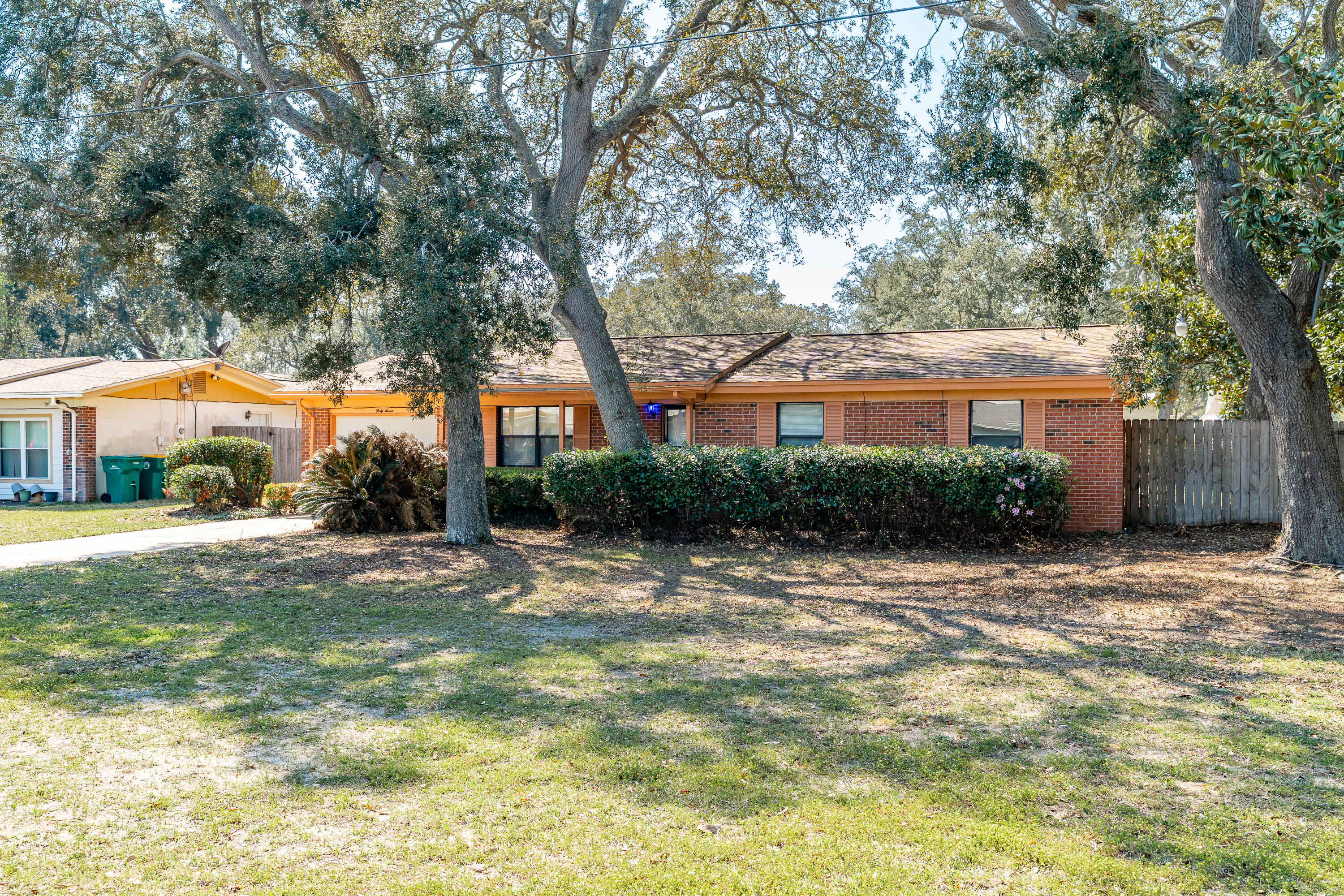 Located on a large corner lot, this classic brick and block home has SO much potential. Four bedrooms, but the primary bedroom could be combined with another and the en suite expanded. Your Florida room leads to a large privacy fenced backyard. Aluminum wiring, older roof, but HVAC still under warranty.