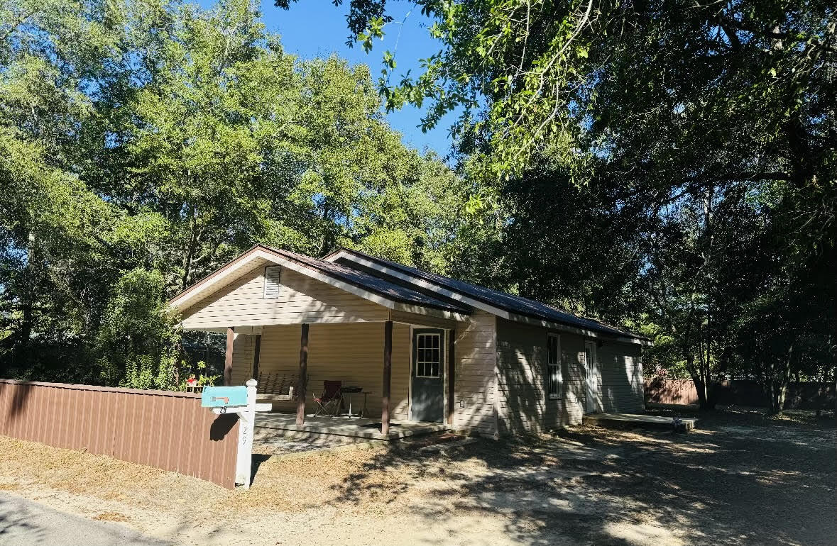 Charming two-bedroom, two-bathroom traditional Florida cottage built in 1924, available for lease just under a mile from the historic district of downtown DeFuniak Springs, FL. This beautifully remodeled cottage features updated electric, plumbing, HVAC, and a metal roof. Situated on a large, wooded lot, the property offers plenty of room for outdoor projects and includes a small shed. The lot is fenced on three sides, providing privacy and a serene atmosphere. Enjoy easy evening strolls or bike rides into the historic district from this cozy cottage retreat! Requirements are a credit score of 600, one year of employment and monthly household income of $3375.