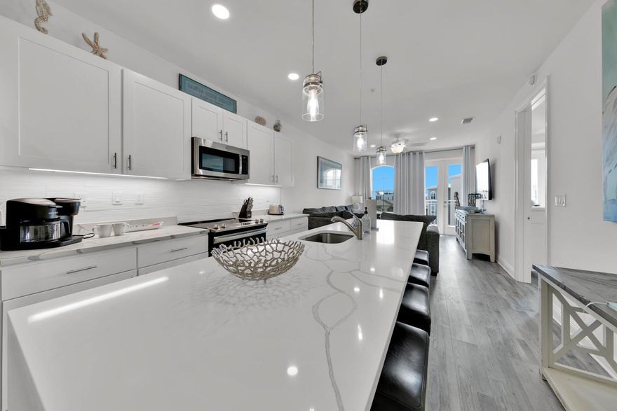 Savor gulf views from this impeccably updated penthouse-level condominium in the sought-after Gulf Place Residences. With two bedrooms plus a bunk room, find the perfect beach retreat with a rare, deeded covered parking spot and only 500' from deeded beach access. A coastal contemporary aesthetic defines the interior space, hardwood floors, designer lighting, and modern furnishing. Highlights of the gourmet kitchen include an oversized waterfall center island with seating for five, quartz countertops, stainless-steel appliances, and white cabinetry. The master suite offers direct balcony access and a spa-like ensuite with dual vanities and a tiled walk-in shower. The guest room and bunk room share access to a hall bathroom with shower/tub combination.  The large, covered balcony is accessed from both the living area and the master suite with ample room to soak in beautiful gulf and community views. Offered fully furnished and move-in or rental-ready, this immaculate residence is a must see!

Popular with vacationers and locals alike, the vibrant Gulf Place community offers on-site dining, shopping, and activities, all in a central location to enjoy the beloved 30A lifestyle. Homeowner amenities include three deeded beach accesses, three swimming pools, two tennis courts, and a grilling area. Also a parking space under the building and a storage unit. 