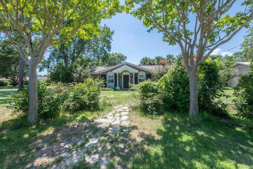 Located on an oversized corner site in the heart of Destin is this lovely four bedroom three bath (or 3 bedroom with study) well finished home rebuilt in 2005. Walking distance to the Destin Elementary or to the east end of the Destin Harbor. The Destin community garden is across the street. So, imagine harvesting your own fresh veggies each day! Lush tropical landscaping surrounds the heated in -ground pool. The summer kitchen poolside and outdoor shower creates an ideal total living space of 3527 square feet to enjoy our moderate climate.