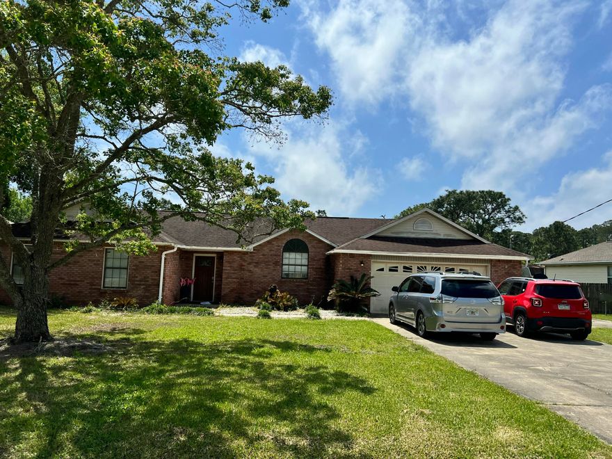 This Spacious Custom-Built 4 BR 2.5 BA home on nearly half an acre (.46 acres) is full of potential and ready for your personal touch!  Due to the age of the roof, this property will likely require cash or renovation loan financing. Inside, you'll find 4 bedrooms and 2.5 bathrooms, with wood flooring in the Living/Dining and tile throughout the rest of the home.  A custom Front Door greets you and there is a half bath for guests near the entrance.  Vaulted ceilings are in the main living areas and the primary suite. The open-concept layout features a large great room with a cultured marble fireplace, an inviting dining area, and a functional kitchen complete with beautiful wood cabinetry, a glass-top range, & refrigerator. The Master Bedroom is spacious and the Master Bath has Cultured Marble Jacuzzi Garden tub, separate shower, and dual vanities.  Additional highlights include an oversized garage with attic storage, an extra-wide driveway, tiled front walkway, and a tiled back patio and porch - perfect for enjoying the outdoors!  While the home needs a new roof and some cosmetic updates (such as small sheetrock repairs), it is structurally sound and full of potential!  Water heater replaced in 2017. Located in the sought-after Holly by the Sea, where residents enjoy access to a wide range of amenities, including a large recreation center with indoor and outdoor swimming pools, a full gym, 8 clay tennis courts, RV campsites, event rental beach house, youth programs, a nearby boat launch, and more! HOME IS SOLD AS-IS.

