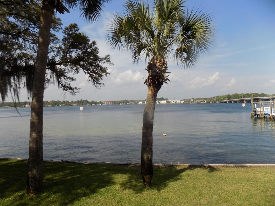 STUNNING views from this gorgeous waterfront townhome with a rare deeded boat slip with a newly installed 10,000 lb boat lift. This home provides you with a tranquil setting overlooking the beautiful Cinco Bayou. The immaculate townhome can function as a 2 or 3 bedroom home and features 3 full bathrooms. The home has unobstructed water views from the living room, kitchen, and master bedroom. The upstairs features two bedrooms both designed as master suites with their own ensuite bathroom and closets. The feature master bedroom has gorgeous views of the water from both the bedroom and garden tub. Downstairs the entryway leads to the office/bonus room which could be a 3rd bedroom with a full bath across the hall. Next, you'll find the great room with fireplace, breakfast bar and more