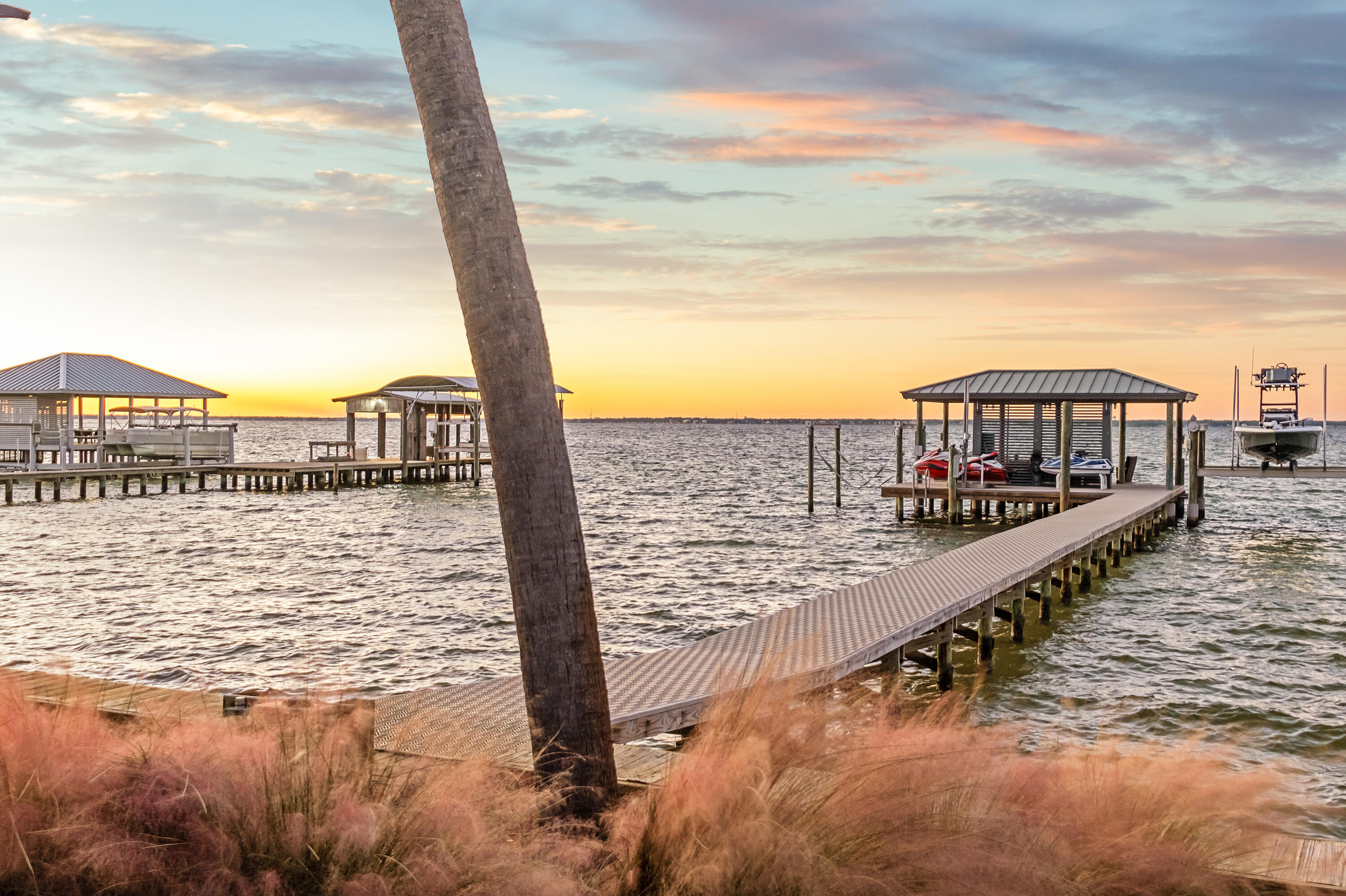 From our family to yours, this property isn't just a home--it's been the backdrop to some of the greatest memories of our lives. Nestled in the heart of Destin, it's more than just a location--it's a sanctuary. When we first moved here, we were hesitant about being in the middle of a vibrant vacation destination. But the moment we discovered this property, we knew it was different. Set on over an acre of pristine waterfront, it feels like living on your very own private island. The hustle and bustle of the outside world fades the second you turn down the driveway. With neighbors who are rarely home, it's a peaceful retreat like no other. And the location? Unmatched. Perched along the coveted emerald tide line, it boasts crystal-clear waters that transform into a Caribbean-like paradise with the incoming tide, which fades to brackish water even just a few homes down to the east. This home has been the setting for thousands of irreplaceable moments: Serene mornings watching the sun rise and the dolphins chasing the mullet fish as if putting on a show. Joyful afternoons leaping off the dock or teaching our kids to swim in the calm, clear waters. Family evenings around the fire pit as the sky paints itself in colors we never grew tired of seeing.
    And the magic? It's real. From spotting dolphins playing under the dock to quiet moments of reflection, this place has brought us more joy than we ever imagined possible. We poured our hearts into making this house a true home. Every inch has been lovingly remodeled to create both beauty and functionality. From the completely remodeled kitchen, featuring the highly coveted 48" Sub-Zero fridge, to the custom waterfront office addition, the theater room with an 11.1 top-of-the-line sound system and dual laser projector, and the master bathroom spa retreat with steam, aromatherapy, chromatherapy, and luxurious touches like a heated towel barevery detail of this home has been thoughtfully crafted for unparalleled comfort and sophistication.
    Beyond the home itself, the property is a true wonderland. Landscaped to perfection, it's alive with naturebox turtles visit each morning, cranes and pelicans glide gracefully through the air, and fruit trees including limes, oranges, avocados, and even pineapples thrive in the lush surroundings. At night, the property transforms into a magical retreat with lighting that highlights the palm trees and seasonal themes. The newly rebuilt dock with Titan X decking and concrete-reinforced sleeves were designed to weather any storm. The 20,000-pound boat lift can accommodate almost any vessel, and the summer water depth is perfect for enjoying endless aquatic adventures.

Opportunities like this are exceptionally rare. Properties along this stretch of emerald-clear water are tightly held, and it's easy to see why. The unmatched beauty, vibrant marine life, and unique tidal clarity make this location one of a kind.