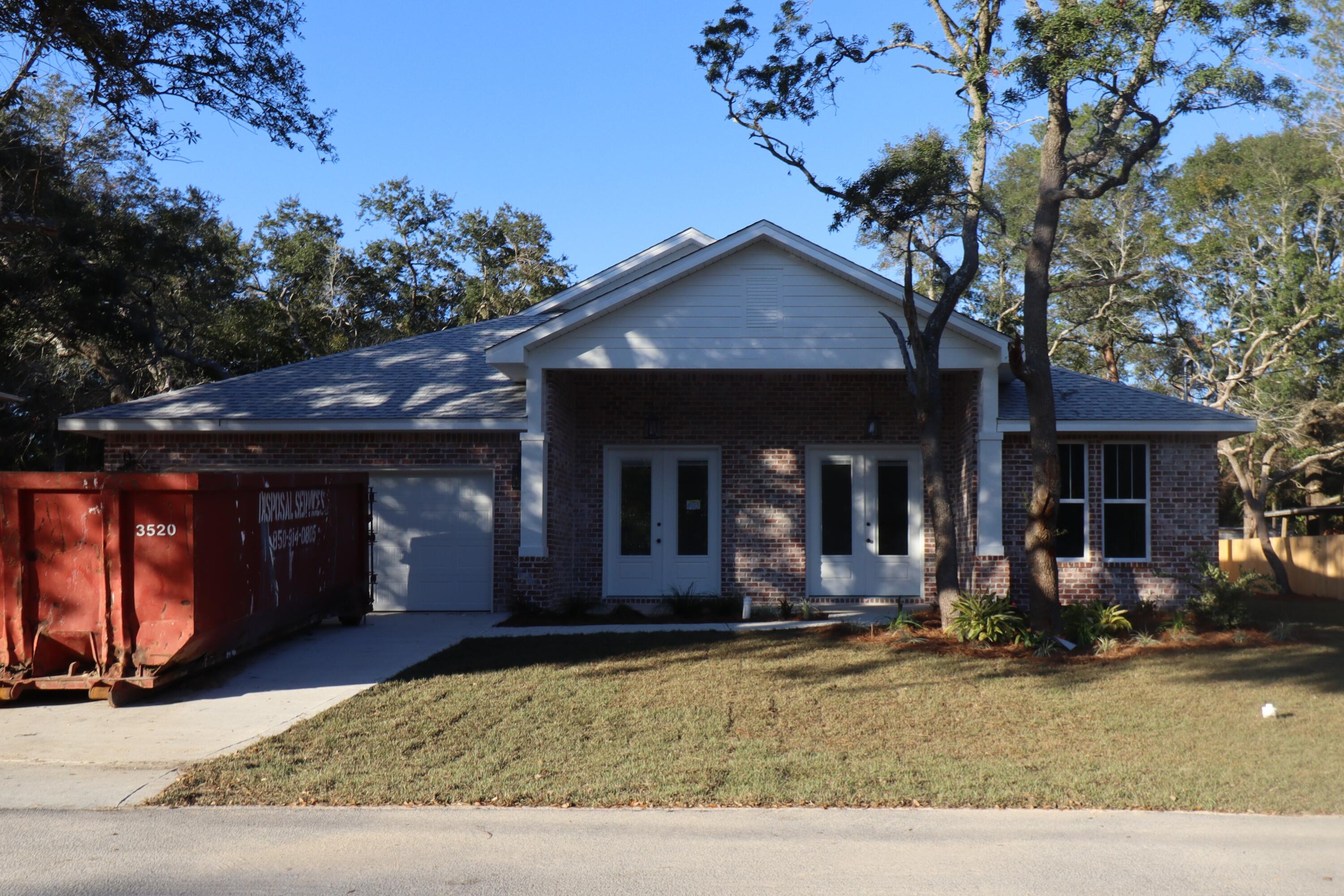 Seller paying $10000 towards closing costs, rate buy down and/or pre- paids. Awesome plan in a quiet neighborhood, super close to shopping and very convenient to both bases. This 4/3 custom brick home has super curb appeal and is constructed on a large lot with beautiful mature trees. There are 10 Ft. Ceilings with impressive crown molding, has plank tile flooring throughout the entire home expect for tile in wet areas, and 5 1/4 '' baseboard. As you enter the home through the large covered porch, bedroom 1 and bath 1 are located at the right of the home. Continuing down the hallway you pass bedrooms 2 and 3 then bath 2 at the end of it. The dining room is at the left of the main front entrance. At the rear of the dining room is the gourmet kitchen which boasts white painted cabinetry, granite countertops, a breakfast bar and stainless appliances. The great room is located at the front of the kitchen and opens to a covered porch that is perfect for entertaining. The large master suite is located at the rear of the home and has a double vanity, 2 large walk -in closets, whirlpool tub and separate shower. Yard is fully sodded/ landscaped and comes complete with a well and sprinkler system. Completion expected in mid January 2023.