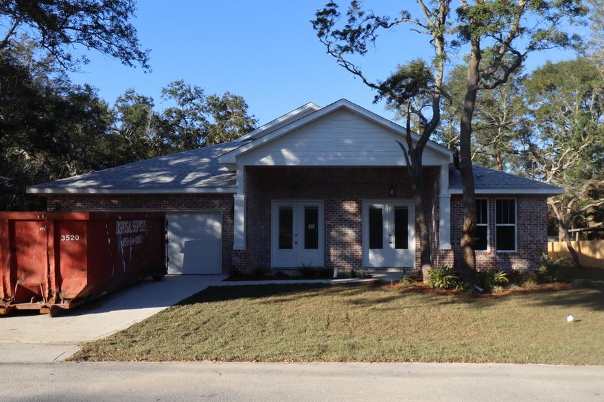 Seller paying $10000 towards closing costs, rate buy down and/or pre- paids. Awesome plan in a quiet neighborhood, super close to shopping and very convenient to both bases. This 4/3 custom brick home has super curb appeal and is constructed on a large lot with beautiful mature trees. There are 10 Ft. Ceilings with impressive crown molding, has plank tile flooring throughout the entire home expect for tile in wet areas, and 5 1/4 '' baseboard. As you enter the home through the large covered porch, bedroom 1 and bath 1 are located at the right of the home. Continuing down the hallway you pass bedrooms 2 and 3 then bath 2 at the end of it. The dining room is at the left of the main front entrance. At the rear of the dining room is the gourmet kitchen which boasts white painted cabinetry, granite countertops, a breakfast bar and stainless appliances. The great room is located at the front of the kitchen and opens to a covered porch that is perfect for entertaining. The large master suite is located at the rear of the home and has a double vanity, 2 large walk -in closets, whirlpool tub and separate shower. Yard is fully sodded/ landscaped and comes complete with a well and sprinkler system. Completion expected in mid January 2023.
