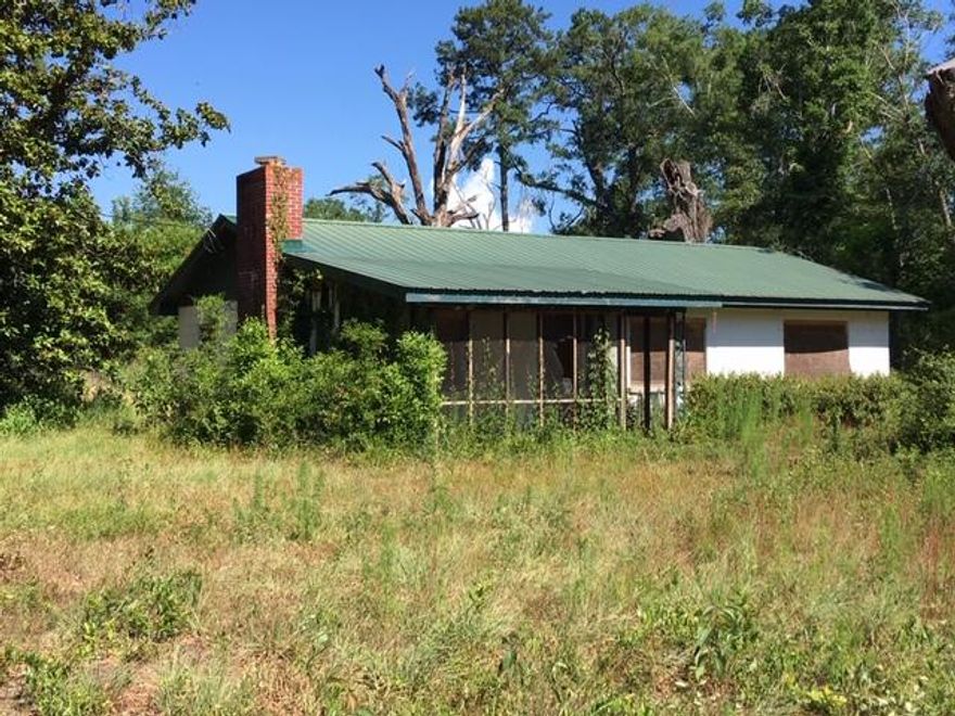 Enjoy the quiet country life on 2+ acres in Red Bay. This classic 1960s block home has a fireplace, metal roof, and covered front porch, and it will be beautiful when it's restored. Perfect for a rehab loan or cash investor. The roof is about 15 years old. Seller got a bid 2 years ago to replace the septic, electrical, plumbing, windows, ceiling, and floor, and was quoted $30,000.