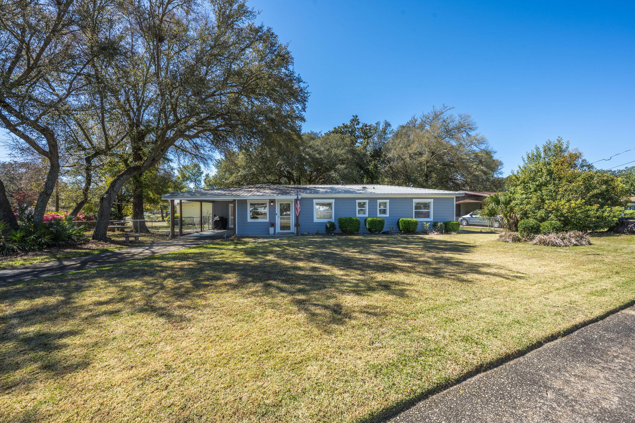 Extensive updates. Desirable corner lot. Peaceful FWB neighborhood. This home is guaranteed to be a favorite. Updates include LVP flooring throughout, fresh carpet, renovations of both bathrooms, and updated interior/exterior paint making it move-in ready. The kitchen features stainless steel appliances, sleek black range hood, brick backsplash, two Lazy Susans, a pantry cabinet, and a large peninsula perfect for entertaining. An open concept design from spacious dining area to living room showcases shiplap details and large picture windows. Not included in the 3-bedroom count: a bonus room off the living room ideal for an office or nursery. Beyond aesthetics: a metal roof, new copper wiring, new plumbing, and a TRANE HVAC system (2012) with a 2015 water heater. A laundry room under the carport was refreshed with new drywall, paint, and epoxy floors, while a large, fully-fenced yard includes a sprinkler system, landscaping, a small shed, and an outdoor seating area. Just outside of the tree-lined street lies a new convenience store 780-feet away, plus Publix + dining options close by. A 2.99% assumable loan is possible for VA eligible buyers!