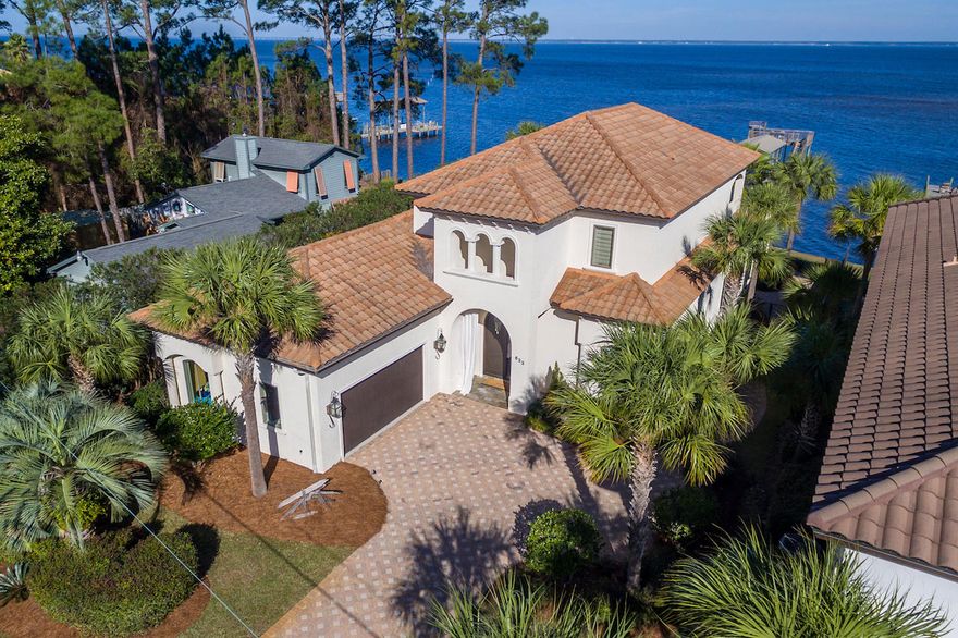 MEDITERRANEAN MEETS COASTAL! THIS GORGEOUS BAYRONT HOME BUILT BY AWARD WINNING DIXON KAZEK CONSTRUCTION HAS BEEN PROFESSIONALLY AND RECENTLY UPDATED WITH AMAZING FINISHES AND DECOR. UPON ENTERING THE DOUBLE SOLID WOOD FRONT DOORS YOU STEP INTO A SPACIOUS FOYER INCORPORATING A 22 FOOT CEILING WITH STUNNING LIGHT FIXTURES AND WINDING STAIRCASE. IMMEDIATELY TO YOUR LEFT IS A STUDY, CURRENTLY SET UP AS A SITTING ROOM FEATURING WOOD BEAMS AT CEILING AND PLENTY OF RECESSED LIGHTING COMPLIMENTING NATURAL LIGHT. OUTSIDE THIS ROOM TO THE LEFT IS A CLEVERLY APPOINTED HALF BATH WITH CUSTOM MILLED WOOD COUNTER TOP WITH VESSEL SINK. BREATH TAKING VIEWS BECKON FROM THE SPACIOUS AND OPEN GREAT ROOM, DINING AND KITCHEN AREAS. GORGEOUS HAND SCRAPED WOOD FLOORS, CAST STONE SURROUND AT GAS FIREPLACE,