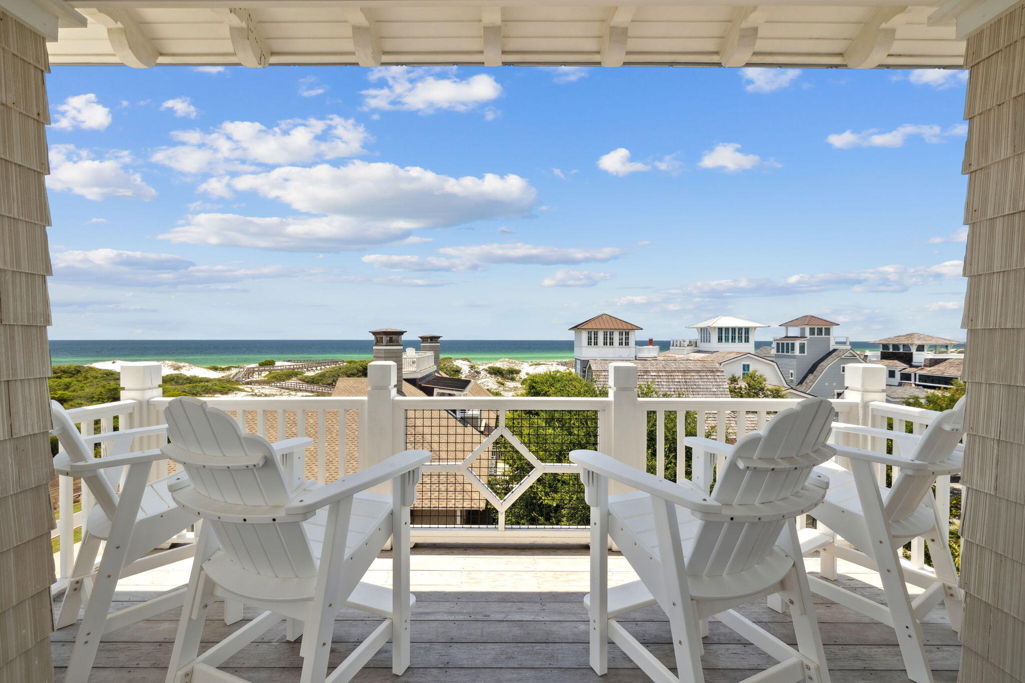 Ideally located in the gated community of WaterSound Beach, 85 S Founders Lane offers a blend of architectural character and thoughtful design, just a short distance from the Dunesider pool and boardwalks leading to the beach. Spanning more than 4,500 square feet across three levels, this six-bedroom, six-and-a-half-bathroom home is designed with comfort and functionality in mind.The first level features a secondary living area, three guest suites--including a custom bunk room--and access to a screened porch overlooking a peaceful outdoor setting. On the second floor, an open-concept layout connects the kitchen, dining, and living spaces, enhanced by exposed brick accents, wood beams, and natural light from large windows. A full accordion door opens an entire wall to the wrap-around balcony, creating a seamless indoor-outdoor flow ideal for entertaining. Two additional guest suites complete the second floor.
The third floor is dedicated to the primary suite, which includes a spacious bathroom with a soaking tub, walk-in shower, and dual vanities. A private rooftop terrace offers additional outdoor living space with expansive views. Additional features include hardwood flooring throughout, designer fixtures, and a layout well-suited for hosting and gathering.