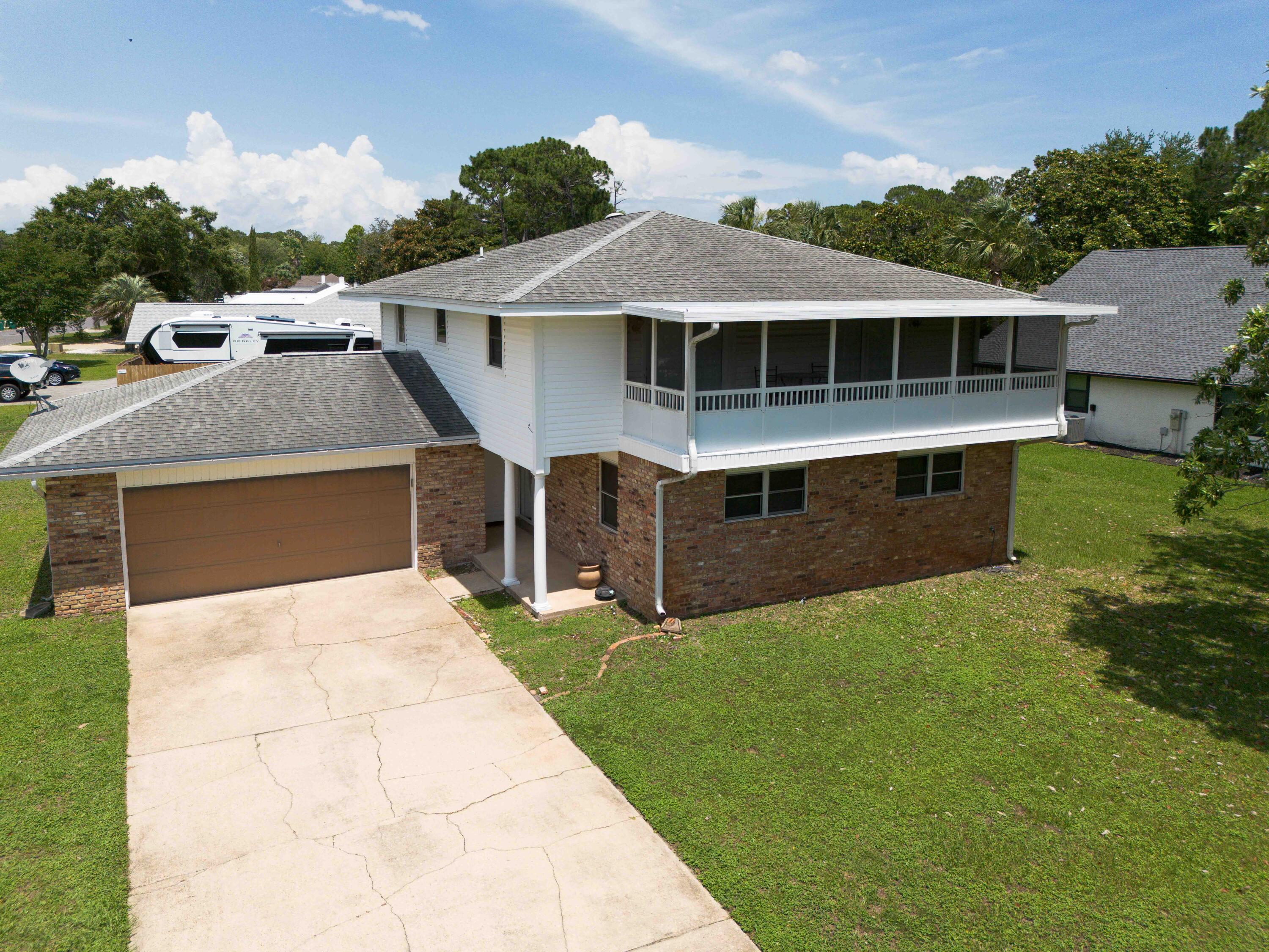 Welcome to Raintree Estates! Beautiful remodeled home on a large corner lot with bay views. Major remodel in 2021 included full kitchen makeover (cabinets, gorgeous granite, 9' bar, beverage fridge, SS Frigidaire Gallery appliances., etc.), smooth ceilings, canned lights, primary bath with walk -in shower, custom tile, dble vanities, LVP throughout, etc. HVAC - 2024, Water Heater 2020. Two bedrooms upstairs have french doors out to the 26' screened balcony with amazing water views. Step out back to the large sun porch and spacious backyard! With voluntary membership in the HOA ($150 per year) enjoy the 1.9 acre Raintree Park just one block away! This is a home you won't want to miss!