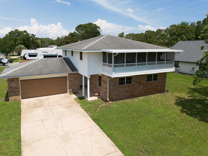 New Amazing Price!  Welcome to Raintree Estates! Beautiful remodeled home on a large corner lot with bay views. Major remodel in 2021 included full kitchen makeover (cabinets, gorgeous granite, 9' bar, beverage fridge, SS Frigidaire Gallery appliances., etc.), smooth ceilings, canned lights, primary bath with walk -in shower, custom tile, dble vanities, LVP throughout, etc. HVAC - 2024, Water Heater 2020. Two bedrooms upstairs have french doors out to the 26' screened balcony with amazing water views. Step out back to the large sun porch and spacious backyard! With voluntary membership in the HOA ($150 per year) enjoy the 1.9 acre Raintree Park just one block away!  This is a home you won't want to miss!
