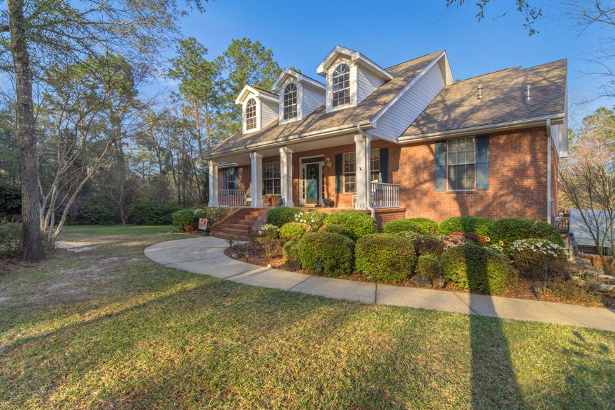 Beautiful colonial on over 2 acres with lake frontage including a babbling creek located in the center of Crestview with easy commute to all the local bases, beaches, and major shopping centers. This beauty provides unique landscaping including a large number of azaleas, camellias, hydrangeas, and various blooming trees watered by an irrigation system that is fed by the lake which is ready for your fishing pole. Home features gorgeous engineered wood floors, stunning views of the yard and lake, and it's very own mother-in-law suite complete with it's own kitchen, living area, bedroom, bath and interior and separate exterior entrances which is all located on the lower level. There is also a great location in the walk out basement for storage and/or man cave that is cooled and heated by a
