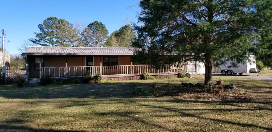 Here is your chance to get away from the congestion of the city and have lots of room to expand. Sit on the front porch and listen to the birds or on the back porch and watch the wildlife. A large cover for your boat or RV, a detached garage and 3 other building you can use for storage. Just some paint and flooring and you are all set.