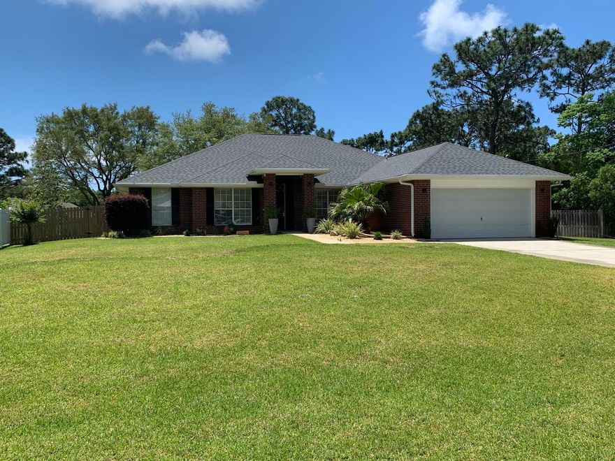 ABSOLUTELY Gorgeous ALL BRICK 4 Bed, 2 Bath, 2580 Sq. Ft, with Formal Dining Room and Bonus Room/Office, Awesome Curb Appeal, All Resting on a Near 1/2 Acre Lot in HOLLEY BY THE SEA Home has custom touches with a Beautiful Open Floor Plan, great for hosting. Cathedral Ceiling, Hardwood Flooring with no transitions to elegant 23'' x 23'' floor tile, outdoor lights on timers. Kitchen has Plenty of Granite Countertop Space, Beautiful solid wood Cabinets, Stainless Appliances, Smooth Top Range, Breakfast Bar AND breakfast area, Pendant Lighting. The Master Bedroom is generous in space, a large Master Bathroom with Garden Tub and Walk-in Shower, Dual Vanities, and His & Her Closets. Beautiful lanai with travertine tile and outdoor TV.