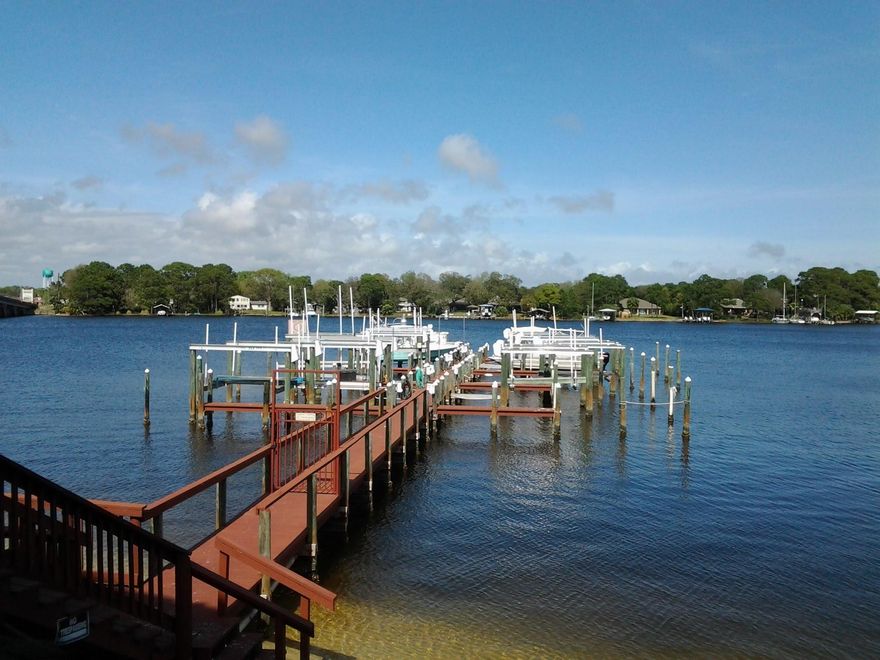 Waterfront and Water view! Now is your chance to own a 3 bedroom/ 3 full bath ground level end unit at Laguna Landing. Gorgeous views of Cinco Bayou and boat slip number 4, 12000 lb. boat lift conveys. Covered parking # 6 and exterior storage convey. KItchen has gorgeous solid surface counters, new cabinets, Stainless Appliances and NEW AC installed 09/19. Water views from every room except one bedroom. Exit through sliding doors toward boat dock and slip number 4 just steps away. Request to see video if you prefer to not view unit in person. Water accessible from side of unit with gate for yard for small pet. Cinco Bayou leads to Choctawhatchee Bay, Crab Island and Gulf of Mexico. Swimming pool and community room. Resort living at home! VA approved and no short term rentals.