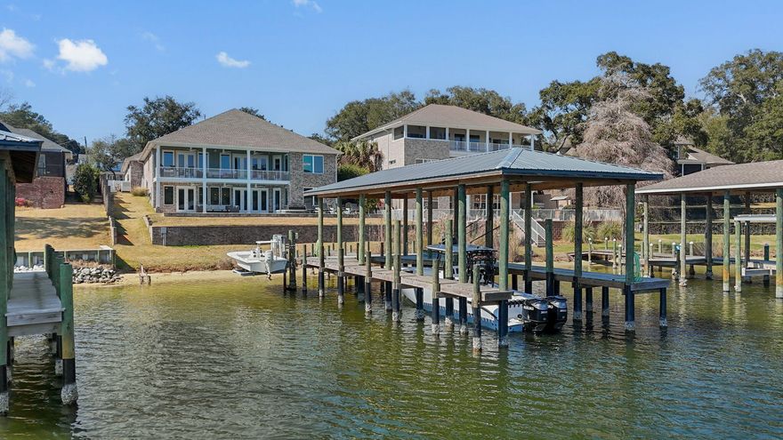 Please see the Video in the photos section and the Features List in the documents section for everything this incredible home has to offer.  Spectacular  Waterfront property with protected deep water boat slip on Poquito Bayou.  If you have ever dreamed of living on the water, this could be your chance.  This is a 6 bed/5 bath, 5000+ sq. ft. home, with an oversized 4 car garage and sits on almost 1/2 acre.  Open and bright with incredible views as soon as you walk in the front door.  On the main level you will find beamed accents on the ceiling in the foyer and living room which has a beautiful quartz stone gas fireplace, large windows and double doors that walk out to the covered, upper patio area.  The gourmet kitchen has quartz countertops, a large center island with cooktop, a