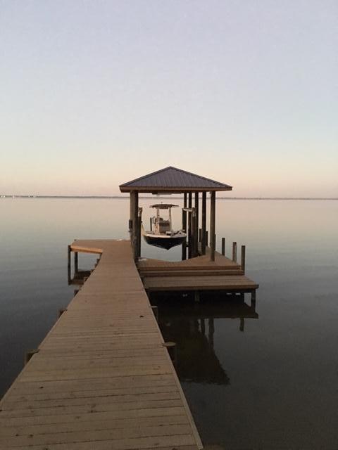 This is one of the best lots in the Estuary. 125 feet on the bay with retaining wall and boat dock and boat house completed. Seller has Full set of construction drawings complete from TS Adams for additional charge. Build your dream home on this amazing lot.