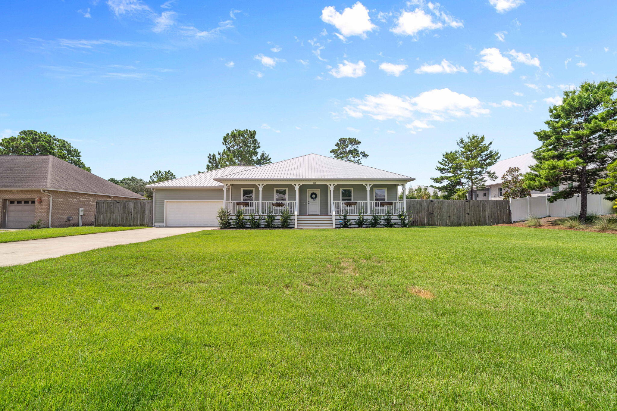 Only 1 mile from Gulf Place and Beach, this charming ALL ONE LEVEL 3 BR 2 Bath home built in 2016 on .62 acre lot with a fenced backyard and a 2-car+golf cart garage! NO HOA so it can be a vacation rental, second home or primary residence, close to golf course and boat ramp. With 2 open porches and 1 screened porch, it offers over 3200 sq. ft. of TOTAL living space! From the charming front porch, enter the spacious living area with vaulted ceilings and an open floor plan, kitchen, dining, making it easy for entertaining and continue the party on your screened porch that overlooks the private backyard with firepit. The kitchen offers stainless steel appliances, open shelving, an island/breakfast bar with a farm sink. The decorative barn door leads to the newly renovated laundry room. There is plenty of storage in the 2 car + golf cart garage with a TESLA Charging station, workbench and wall-mounted organization system for all your paddleboards. There is an outdoor shower located right outside the garage. From the open living area, double doors lead to the primary king-size suite with a new $4000+ custom closet system. The primary bath has an extra large shower, double vanity and separate water closet. Two spacious guest bedrooms overlook the front porch are light and bright and there is a guest bath conveniently located. The backyard is huge and is your blank canvas to install a pool, pickleball court, putting green or RV and boat parking with access through the double gate on the west side of the 116' wide lot. Located in beautiful South Walton near the beach, golf course and the Cessna boat launch! Recent improvements of over $75,000 include NEW HVAC, NEW TESLA CHARGING STATION, NEW PAINT INSIDE AND OUT, NEW SOD, NEW IRRIGATION SYSTEM, NEW GUTTERS, NEW CUSTOM CLOSET, NEW LAUNDRY ROOM CABINETS, SINK AND COUNTERTOPS!