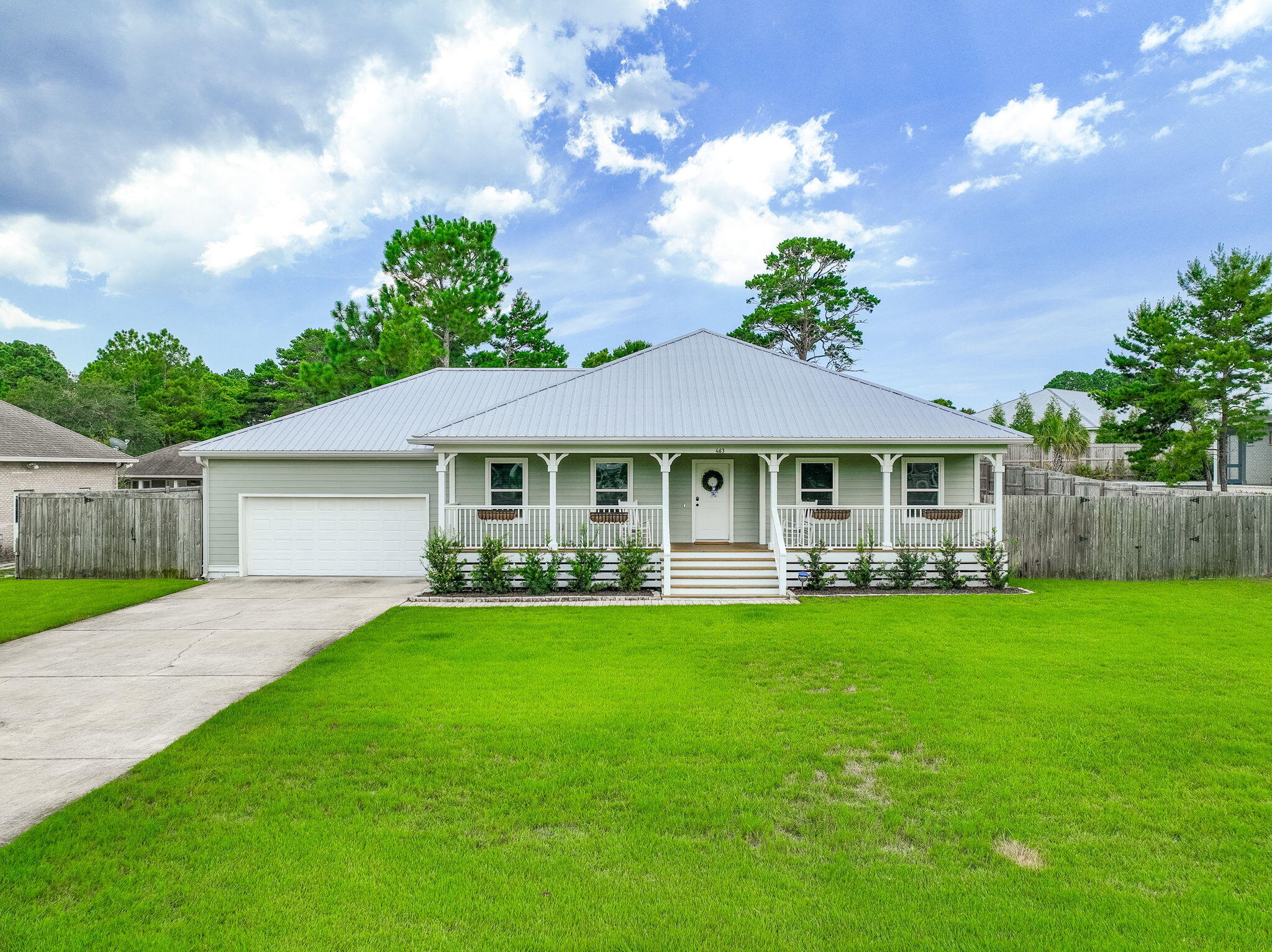 Where else south of 98 can you find a newer, ONE-LEVEL home on a .62 acre lot with NO HOA? Only 1.2 miles to Ed Walline Beach access and Gulf Place restaurants, coffee shops, boutiques, etc., this unique 3 BR 2 Bath home is ''insurance-friendly'' built in 2018 with a metal roof on a high and dry .62 acre lot. With 1909 sq. ft. of heated and cooled space plus another 1325 of porches and a 2-car + golf cart garage for 3234 Total sq. ft! Recent improvements include NEW HVAC, NEW TESLA CHARGING STATION, NEW PAINT INSIDE AND OUT, NEW SOD, NEW IRRIGATION SYSTEM, NEW GUTTERS, NEW CUSTOM CLOSET, NEW LAUNDRY ROOM CABINETS, SINK AND COUNTERTOPS! Although this neighborhood is mostly primary residences, there is NO HOA, so it can be a vacation rental, and you can park plenty of cars, an RV or boat. From the front porch enter the spacious living area with vaulted ceilings and wooden beams, into an open floor plan with kitchen, bar and dining area making it easy to entertain. The double doors lead to the primary suite with windows overlooking the huge back yard. Stay organized with the new custom closet system in the walk-in closet. The primary bath has an extra large shower, double vanity and separate water closet. The other 2 spacious bedrooms overlook the front porch are light and bright. There is a barn door leading to the laundry right off the kitchen/dining area. There is plenty of storage in the laundry room and in the 2 car + golf cart garage with a TESLA Charging station, workbench. The screened porch off the living room offers a great space for pets, yoga, or just relaxing. The huge 2/3 acre lot has a fenced back yard where you can do a home addition and still have room for a pool, pickleball court, putting green or RV and boat parking.