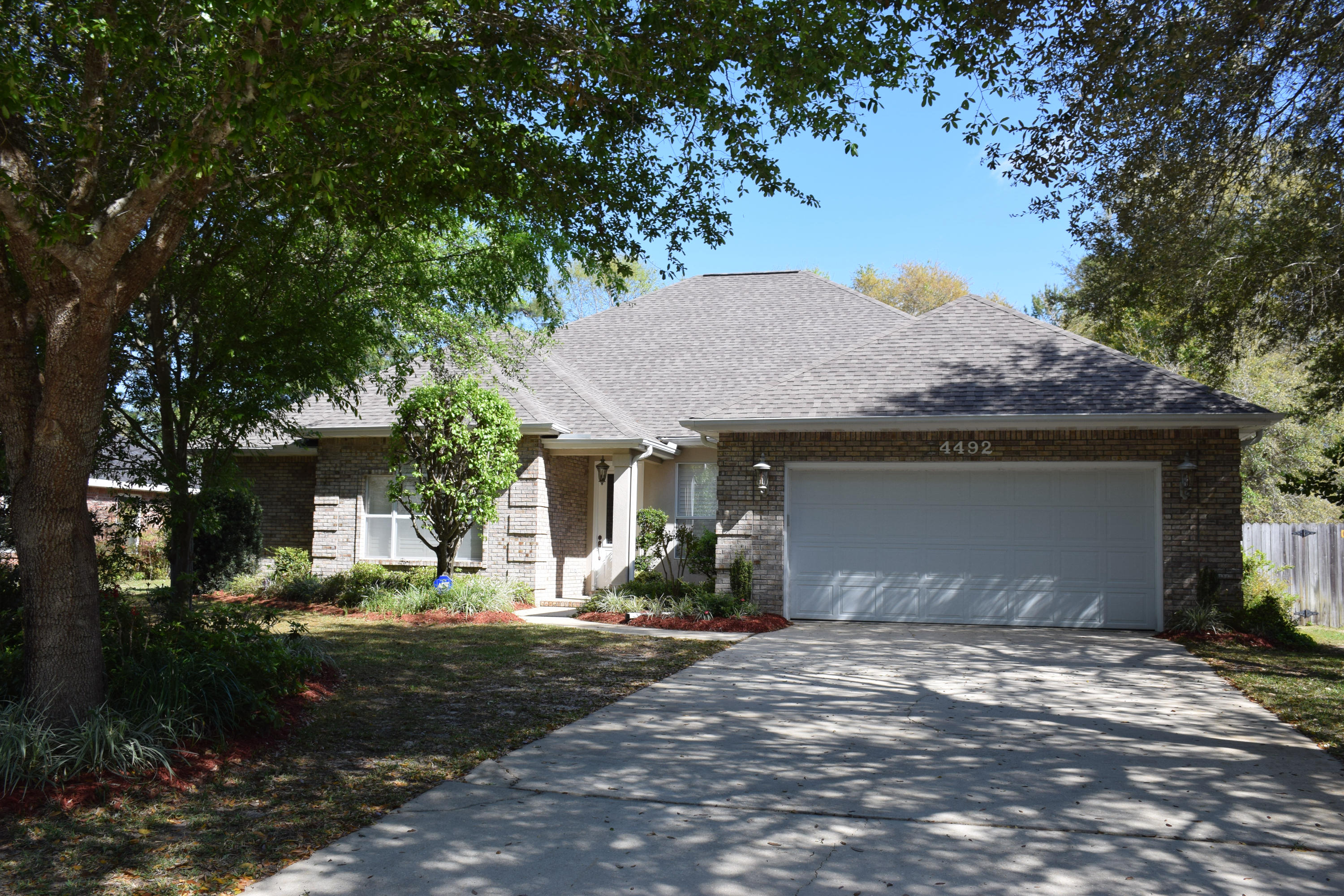 What a fabulous home! In like-new condition complete with a $16,000 dimensional shingle roof that's less than a year old. The 9' and 10' ceilings are trimmed with crown molding. Tile floors flow throughout except for plush carpet in the living room and bedrooms. The creativity of the builder shows from the time you open the front door into the entry. Not only is the place to greet friends and family but the dining room is there as well. So have a big party and spread out! There's definitely room here. The cozy living room is accented by a beautiful window finished with the shutters you'll see throughout the house. The pretty gas log fireplace provides a showplace for your favorite art and memorabilia. Even though it's also located off the entry, the master offers a lot of privacy
