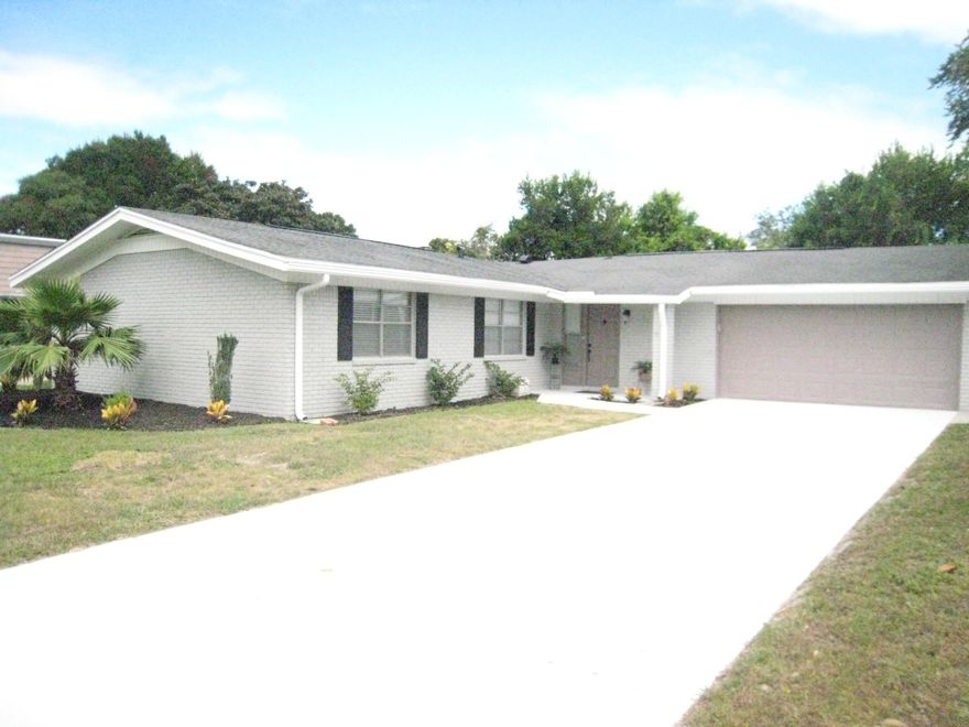 WOW! Look at this renovated beautiful home! All you have to do is move in. It is sparkling clean and ready for your family. Four bedrooms and two baths of pure renovated luxury. The kitchen is equipped with new cabinets with self-closing doors, new granite countertops and stainless steel appliances. The home has been repainted inside and out. All the fans and fixtures are new. There is a new 50 gallon hot water heater too. There is new maintenance-free tile floors and new carpet in all the bedrooms. On the back of the house, there is a heated/cooled sunroom and a screened porch. This is an open floor plan and the living room features a large fireplace for those cozy evenings. The bathrooms are renovated with new tile and vanities. Don't miss out schedule your showing today!