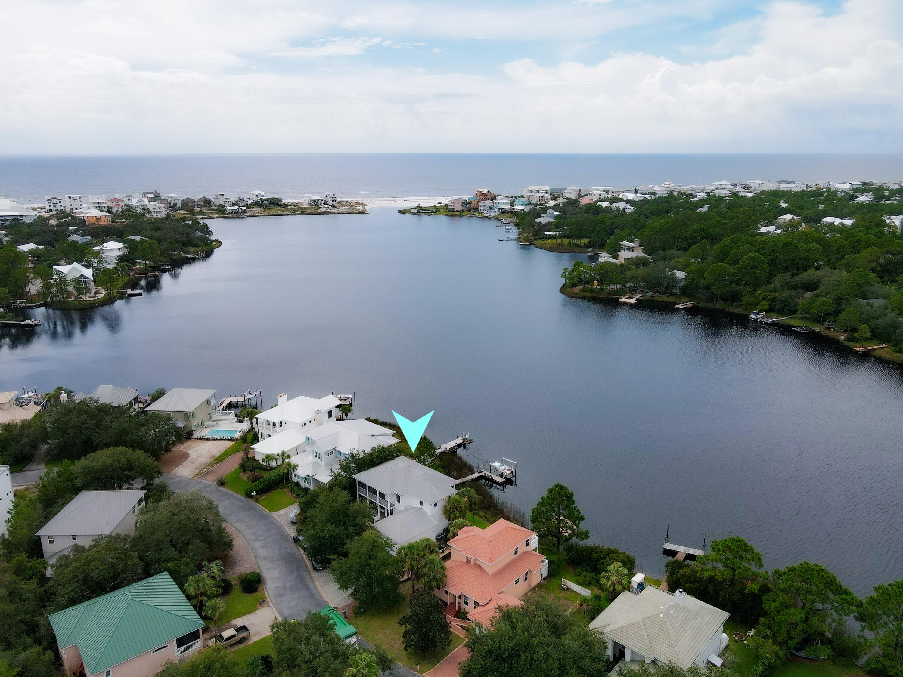 Enjoy pristine views of Eastern Lake and the Gulf from this waterfront residence in the gated community of Lakewood Pointe Estates. Perfectly positioned on the east side of the lake, this luxurious 2 story residence affords stunning views from every room. Enjoy waterfront living at it's finest with your own dock with boat lift. Go to the beach in style as you cruise across one of 30A's most popular coastal dune lakes to the beach access just to the south. Beautifully maintained home with open floorplan kitchen/living area on the main level coupled with a downstairs bedroom, bath, and garage. Upstairs contains the huge master suite, featuring an abundance of windows to absorb the views of the lake and gulf. The home has an plethora of covered porches on both sides of the home to enjoy the