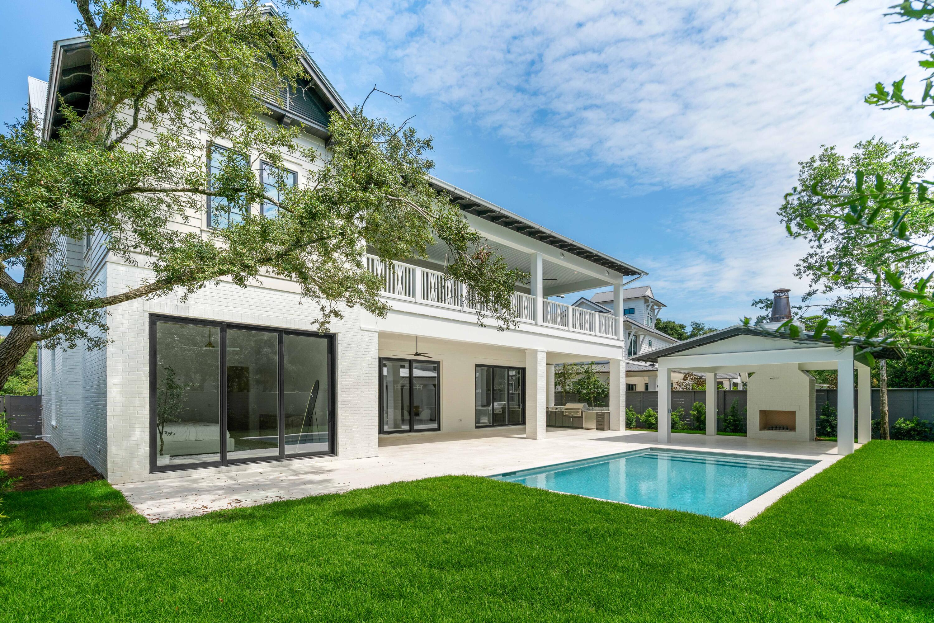 Amazing brand new custom beach home located on the east end of 30a in a lovely Old Florida neighborhood with beautiful, mature trees lining the street & convenient Dune Lake and Public Beach access! This luxurious 5 bedroom, 6 bath beach residence was designed for either full time living or as a second home/vacation rental property. The open concept layout encourages an indoor/outdoor lifestyle with a seamless flow from the interior of the home to the spectacular outdoor space, which features a large central porch with a Summer Kitchen, a separate Cabana porch & a heated Saltwater Pool! Features include 12 ft beamed ceilings, Thermador appliances, Quartz & Marble countertops, Shiplap walls, Cypress ceiling and wall accents, Oak hardwood floors & En Suite baths with frameless glass showers