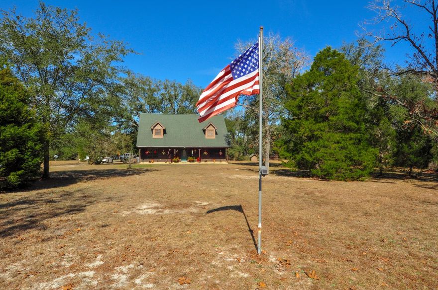 Unique, quiet, private...just a few words that describe this beautiful 2+acres property with 1,913 sqft home and so much more! The 2BR/2BA custom built home includes cedar walls with extra insulation, wood-look tile floors, stainless steel appliances, custom cabinets, and a wood-burning fireplace. The two bedrooms and a bath and located on the second floor, but there is an office and full bath on the first level that could easily become a 3rd bedroom. The entire property is fenced and there is a workshop and carport with power and can handle several vehicles, a greenhouse, pole barn, covered entertainment pavilion with pot-bellied stove, RV/boat parking with hook-ups, and the property is dotted with numerous fruit trees and bushes. Additional features include a 245' well, extra storage