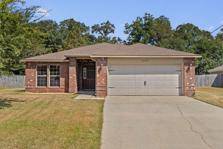This all-brick 3-bedroom, 2-bath home offers the perfect blend of comfort, style, and convenience. Featuring 1,922 sq. ft. of living space, a two-car garage, and a large fenced backyard on a .36-acre lot, this property is a true find. Beautiful luxury vinyl flooring leading into a spacious open floor plan. The family room flows seamlessly into the dining area and  kitchen, complete with granite countertops, stainless steel appliances, a wrap-around breakfast bar, ceramic tile flooring, and ample cabinetry. A walk-in pantry and separate laundry room add to the home's functionality. The private owner's suite is tucked away just off the family room and features double doors, a spacious walk-in closet, dual vanities, soaking tub, and separate shower. Two additional bedrooms and a second full bath are thoughtfully designed for comfort and privacy. Enjoy the outdoors with a large fenced backyard, perfect for entertaining, gardening, or relaxing under the covered back porch. With no HOA. Ideally located near Baker School and just a short commute to local military bases, shopping, and dining, this home is move-in ready and waiting for you. Don't miss the opportunity to make 5609 Price Plantation Rd your new address!