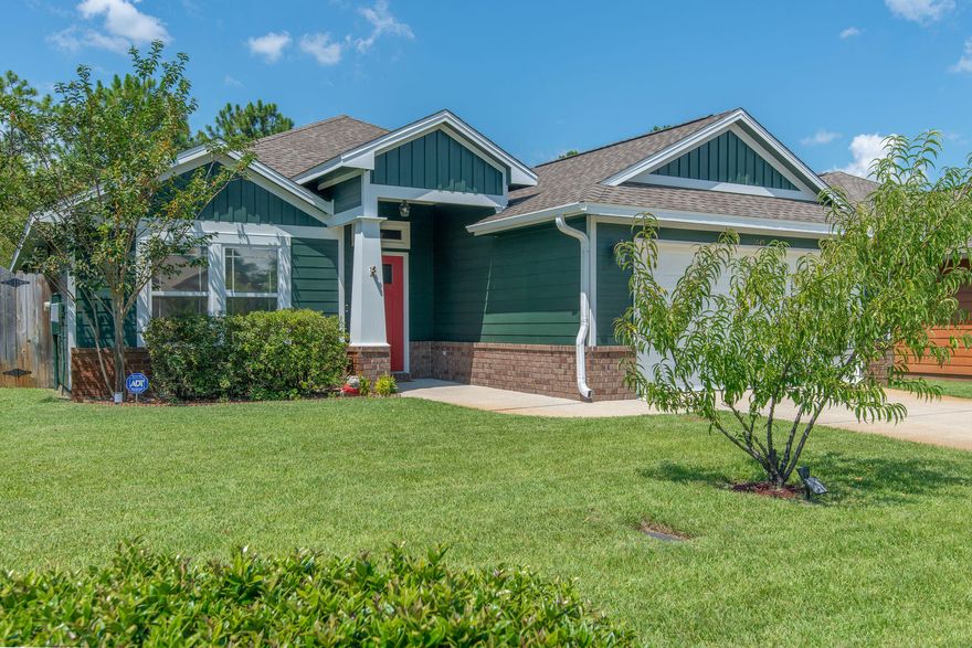 This 3br/3ba craftsman is located in East Navarre with a short commute to shopping, Hurlburt, beaches, and schools. The immaculately maintained home boasts a freshly painted exterior and manicured lawn. Spacious living room has an open floor plan with wood laminate floors, crown molding throughout, and custom foyer shelving. The formal dining room has an extra splash of style with newly installed wainscotting and a tray ceiling. The kitchen is complete with stainless appliances, granite countertops, under cabinet lighting and tile in all wet areas. The master suite is your retreat complete with tray ceiling, while the master bath has his and hers walk-in closets and dual vanities. The fully fenced backyard has a covered patio that offers a perfect oasis to enjoy the weather and entertain.