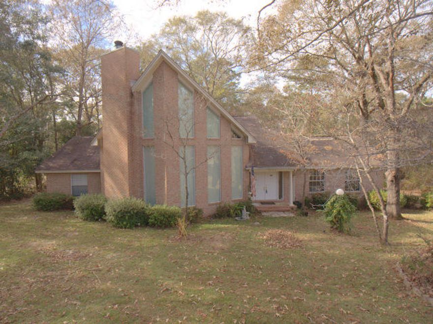 This is a ''one owner'' custom built home with soaring 25 ft Cathedral ceilings. The master suite is upstairs overlooking the great room and the beautiful fireplace surrounded by a stone wall going over 20 ft high. This home has so much potential to satisfy many different wants and needs in a home. Situated on a one acre lot with mature shade trees and plants, there is a long paved driveway leading into the side load garage. Out back is very peaceful, with expansive decking for entertaining large crowds. Inside there are 3 bedrooms with 2 on the main level and the master suite is located upstairs by itself, away from it all. This established neighborhood is a much sought after area in North Crestview that isn't available very often, so take a closer look today. Low, county property Taxes.