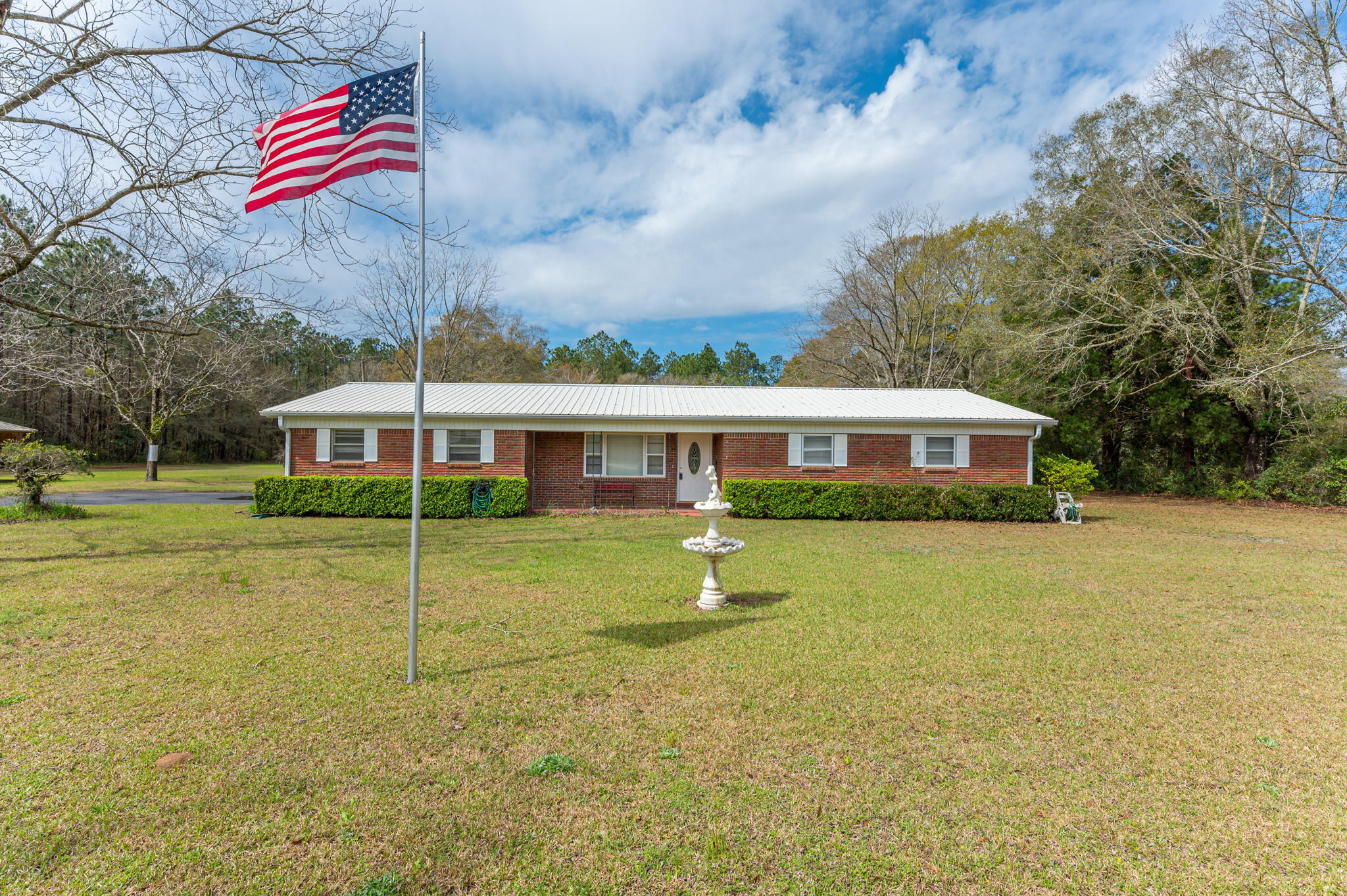 Well maintained 3 bd/2 ba ranch style home situated on a sprawling two acres in Baker. The property is scattered w/ beautiful mature pecan and fruit trees, a gazebo for gathering w/ friends and family, a nice workshop w/ power and an additional storage building. The all brick home features a small front porch and 2 car side entry carport. The home has both a living room and den area. The kitchen boasts solid wood cabinets, updated laminate countertops, newer white appliances and has an adjoining dining area. The bedrooms are all a good size. Come check out this great property! Buyer to verify all areas of importance.