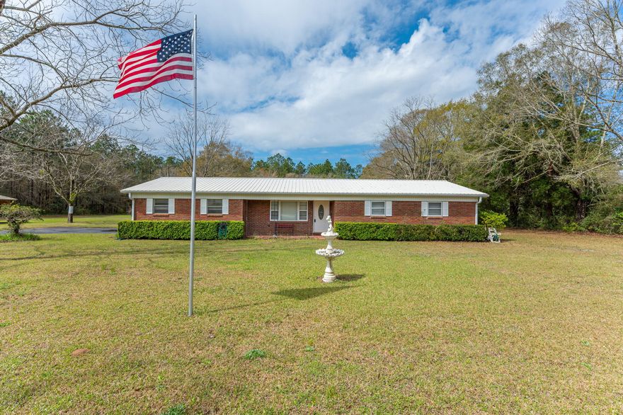 Well maintained 3 bd/2 ba ranch style home situated on a sprawling two acres in Baker. The property is scattered w/ beautiful mature pecan and fruit trees, a gazebo for gathering w/ friends and family, a nice workshop w/ power and an additional storage building. The all brick home features a small front porch and 2 car side entry carport. The home has both a living room and den area. The kitchen boasts solid wood cabinets, updated laminate countertops, newer white appliances and has an adjoining dining area. The bedrooms are all a good size. Come check out this great property! Buyer to verify all areas of importance.