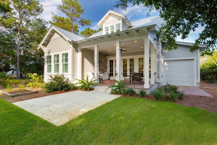 Traditionalists at heart will love the presentation of this charming home in Olde Towne Crystal Lake, complete with Southern-style front porch and white picket fence. Rocking chairs on the brick paved veranda are a gentle reminder to slow down and ''take time to smell the roses''. Double entrance doors and hardwood foyer provide a welcome into this nearly new home, whether it's intended to be a full-time resort home or vacation get-away. There is a synergetic flow from the sitting room to the open living room and formal dining area to the arctic white kitchen with its apron-front sink and granite countertops. The previous owner is a chef, so there's a top-notch array of stainless-steel appliances and storage in the well-designed kitchen. A central island provides additional prep space when