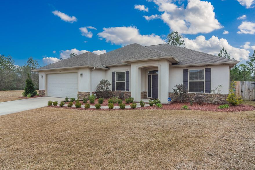 This home is where your heart wants to live! Tucked away on a quiet residential loop SOUTH OF I-10, discover a high quality Key Lime Construction home chalk full of curb appeal and a thoughtful, functional design. Meticulously and lovingly maintained inside and out, it not only looks good but it lives extremely well! Inside, find unexpected, high-end finishes and materials throughout - granite counters in the kitchen as well as both full bathrooms, crown molding, pocket doors, separate laundry room with cabinetry, super-sized 25'x26' garage, and numerous, well-placed storage closets. The split bedroom layout places a generous and open kitchen, dining, and living space at the center of the action with views of the towering pines out back. Formal dining room at the front of the home is